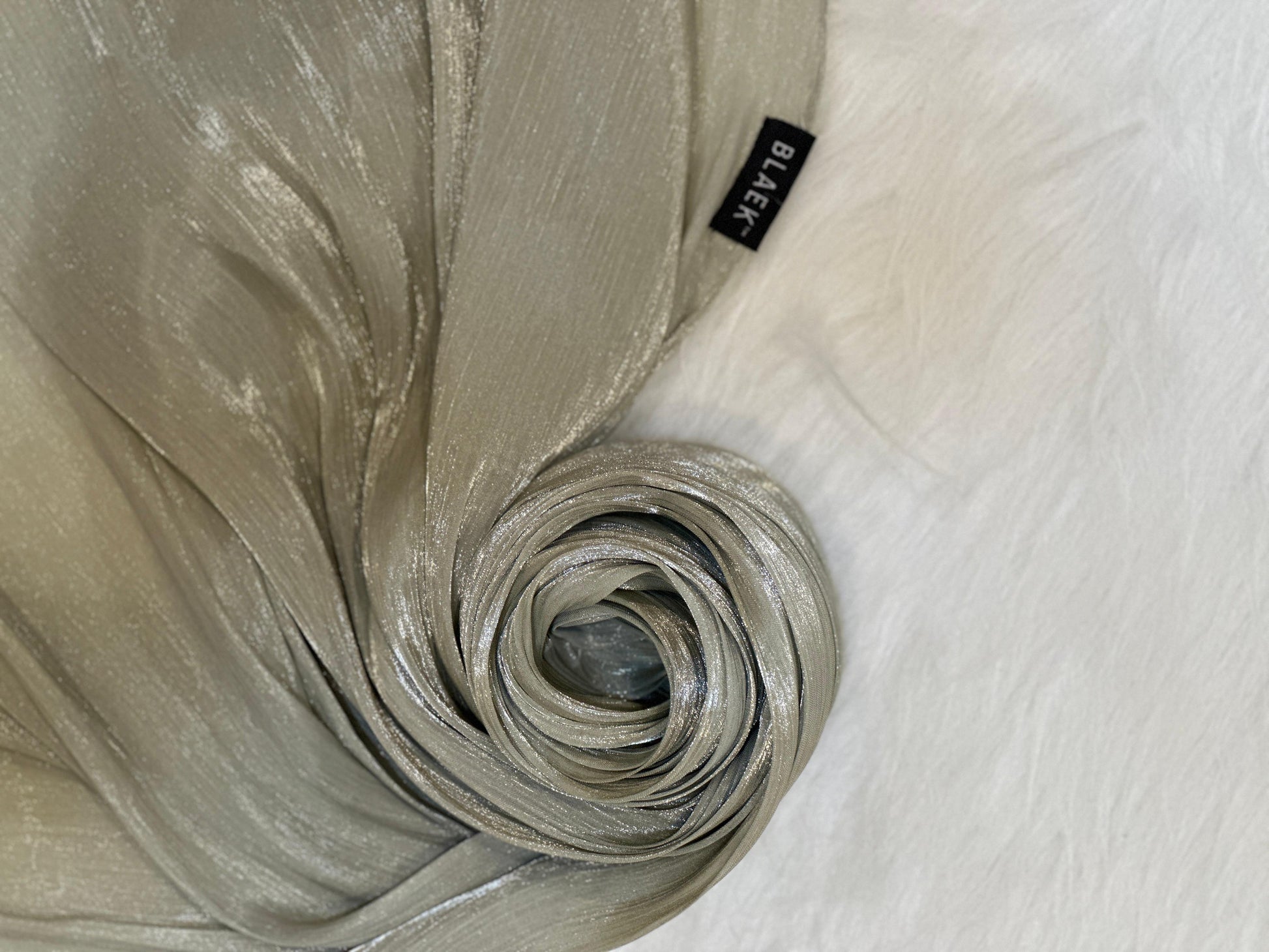 Artichoke Shimmer Hijab arranged in a round swirl to highlight soft shimmer.