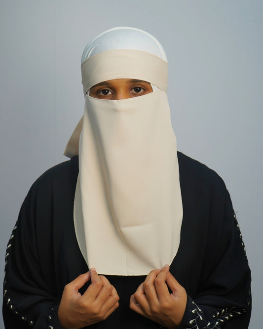 Front view of beige one-layer crepe chiffon niqab with tie-back straps.