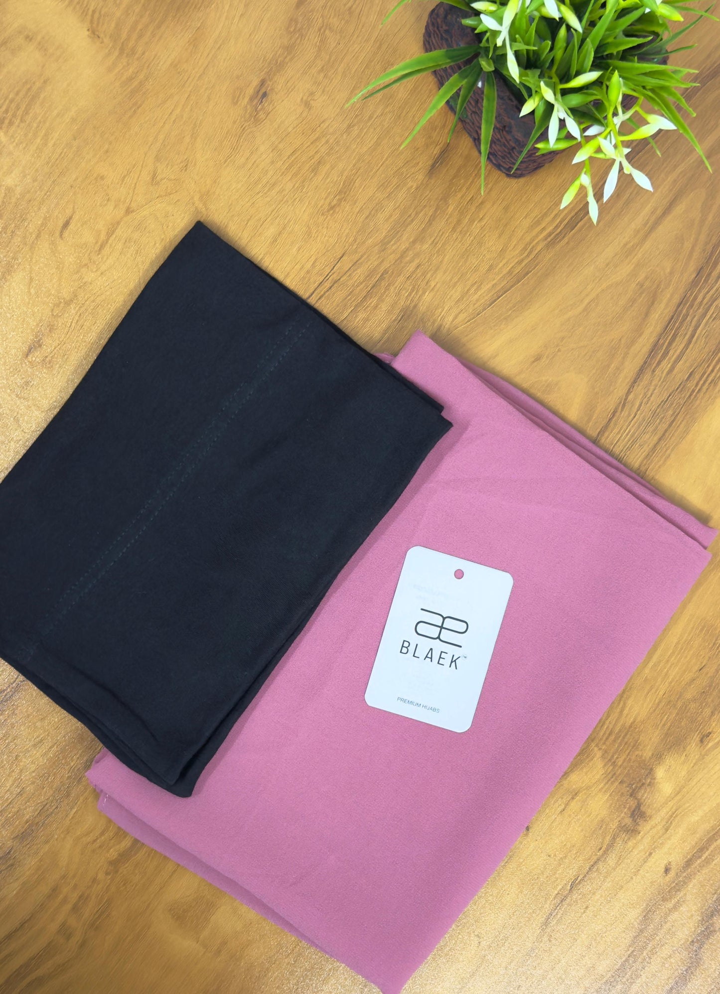 Dusty puce hijab matched with a bold black cap for a graceful combination.