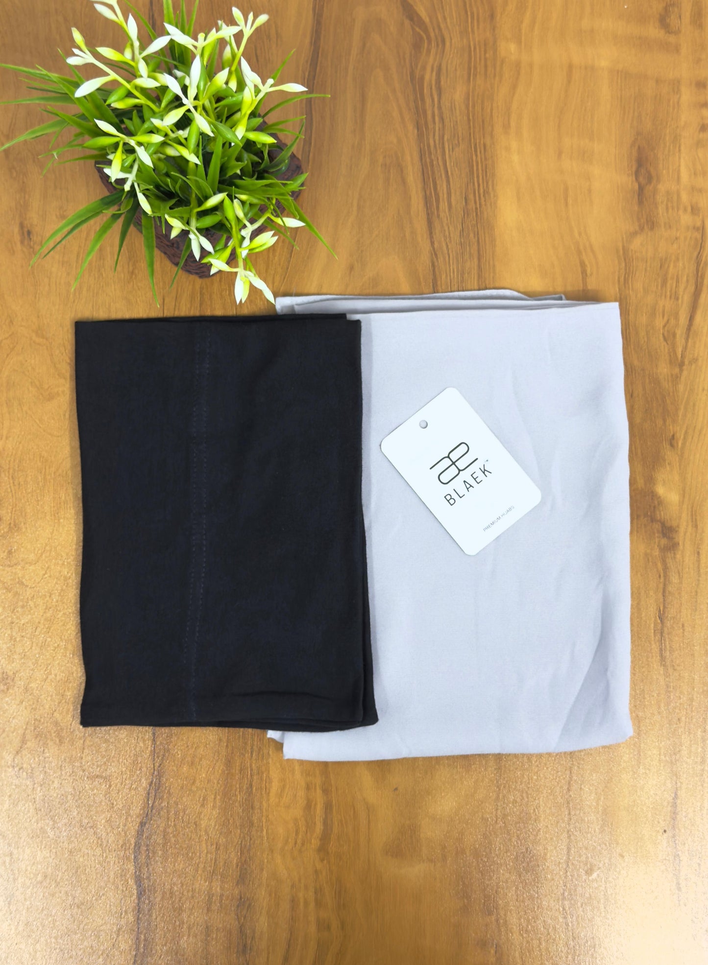 Soft silver hijab complemented by a snug black undercap.