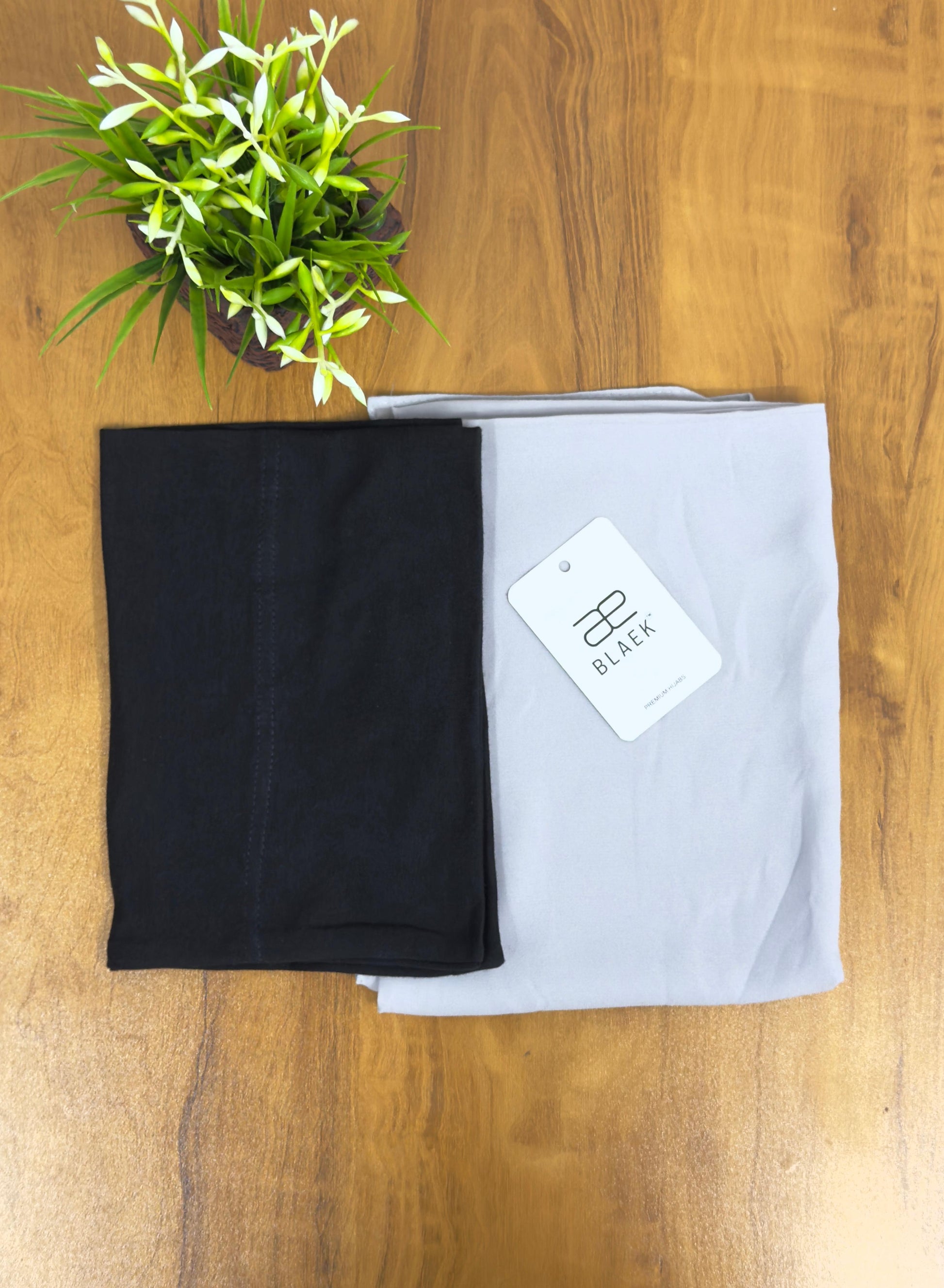 Soft silver hijab complemented by a snug black undercap.