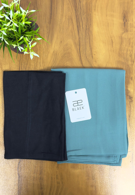 Cool-toned mint hijab with a sharp black cap for effortless style.