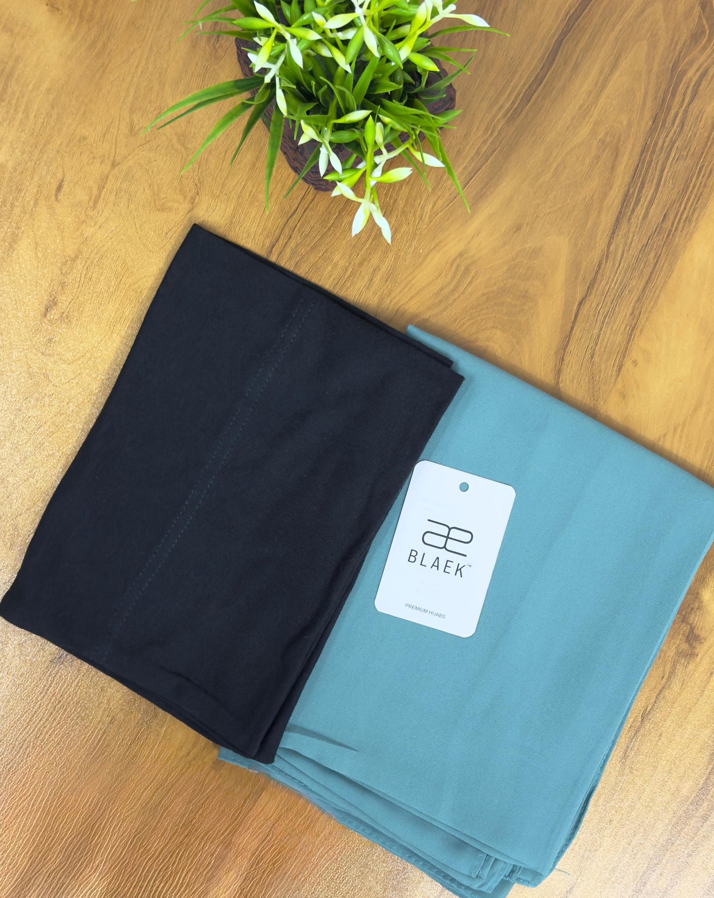 Refreshing mint hijab with a structured black cap.