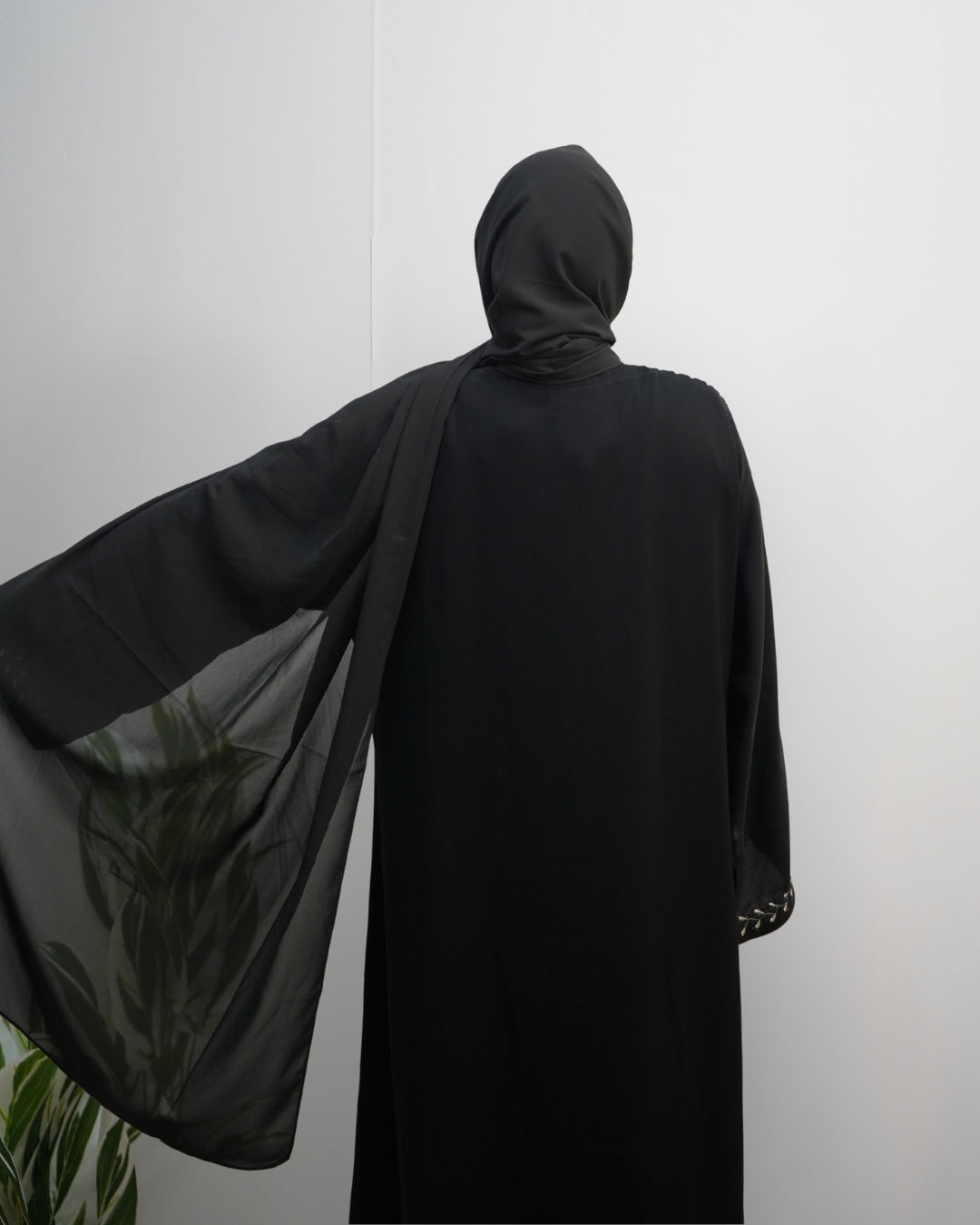 Lightweight breathable black chiffon scarf with neat stitched edges.