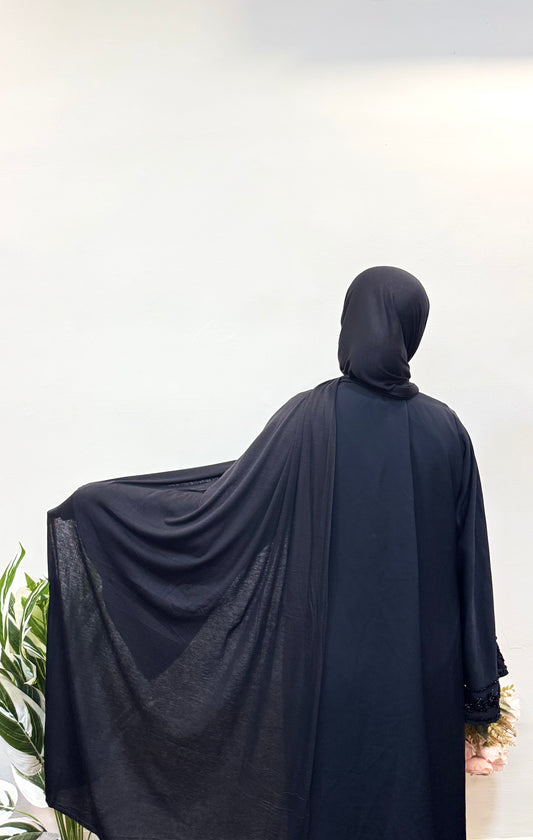 Elegant black jersey hijab with soft, flowing drapes for a sleek and modest look.