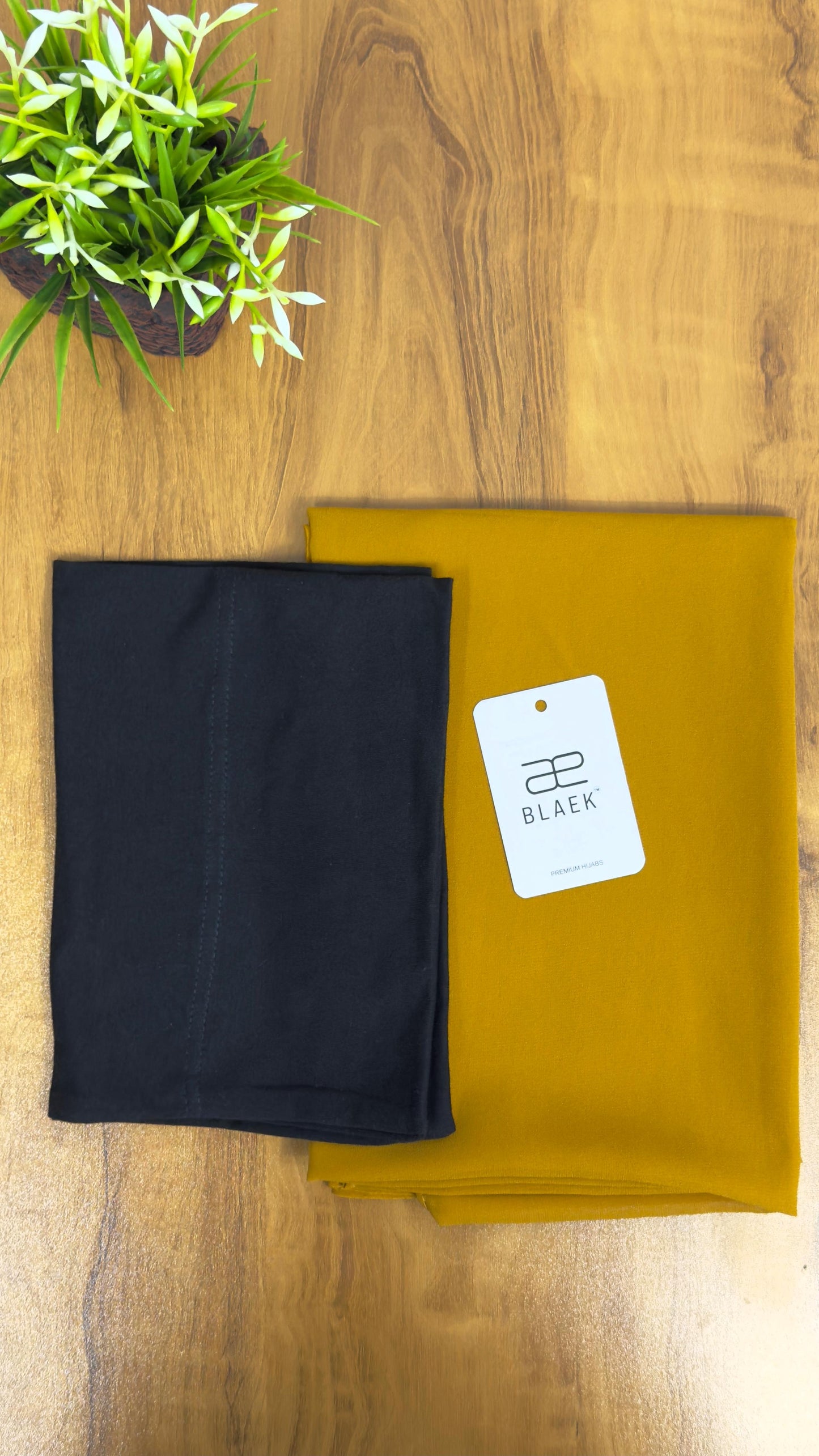 Bold mustard hijab featuring a snug black cap and hidden magnets for a seamless look.
