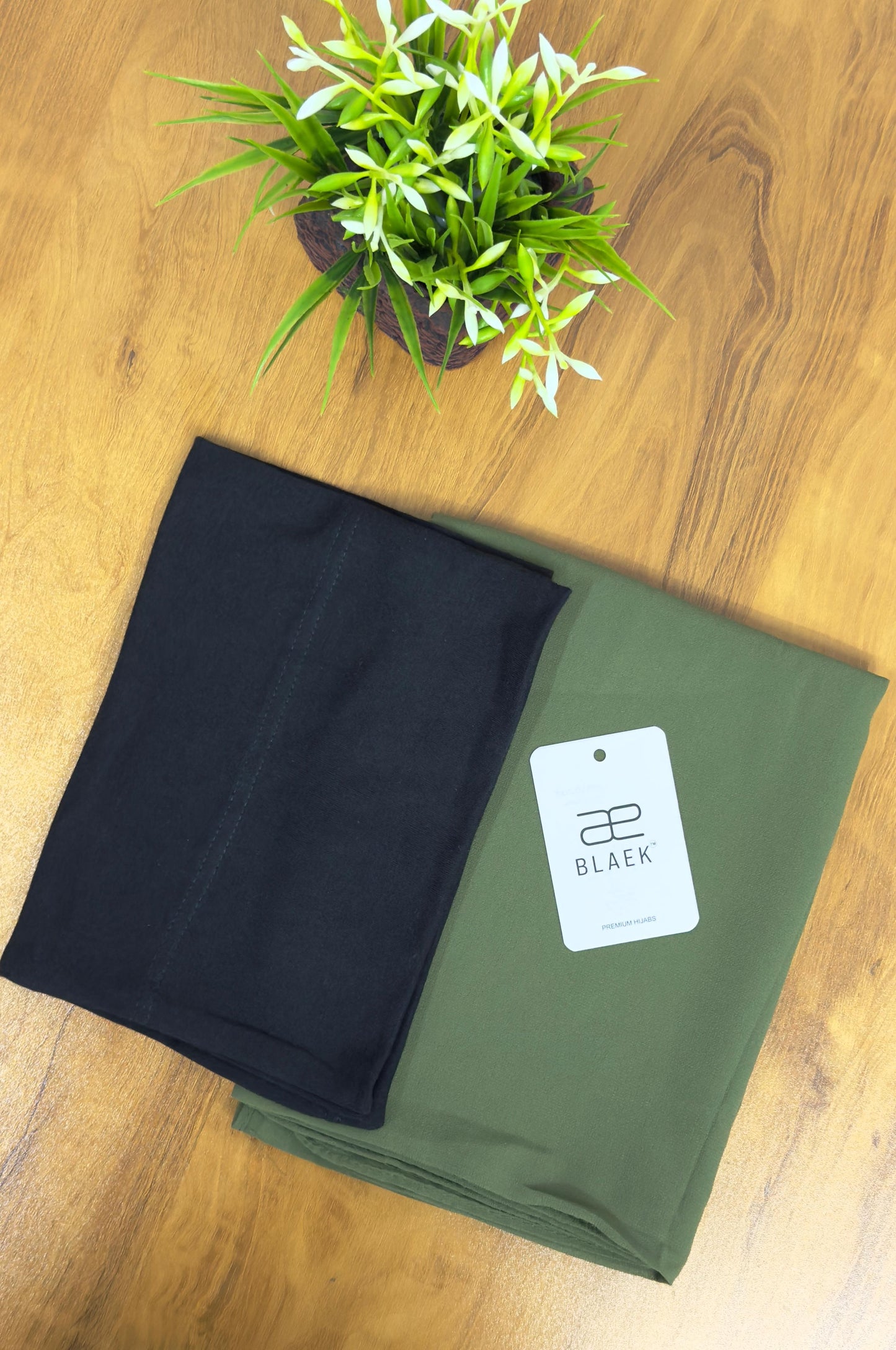 Elegant olive green hijab with a structured black cap.