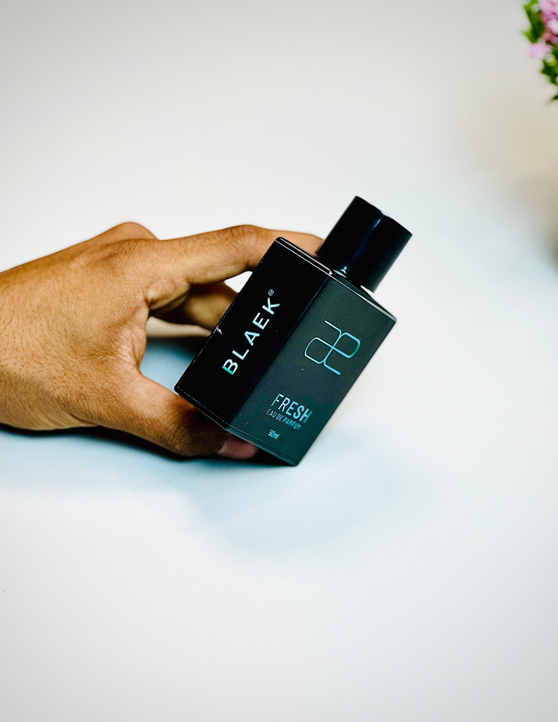 Blaek Fresh Perfume (50ml) shown in hand to highlight size and design.