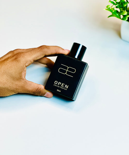 Hand holding Blaek Open Perfume (50ml) with a clean and bold grip.
