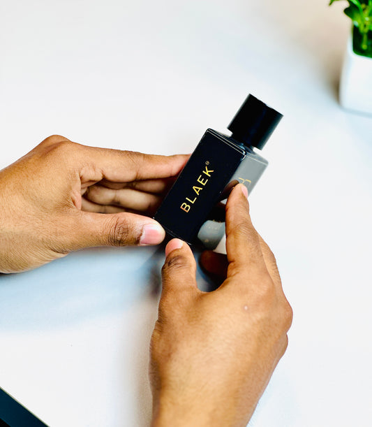 Person holding Blaek Oudh Perfume (50ml) to show bottle design and size.