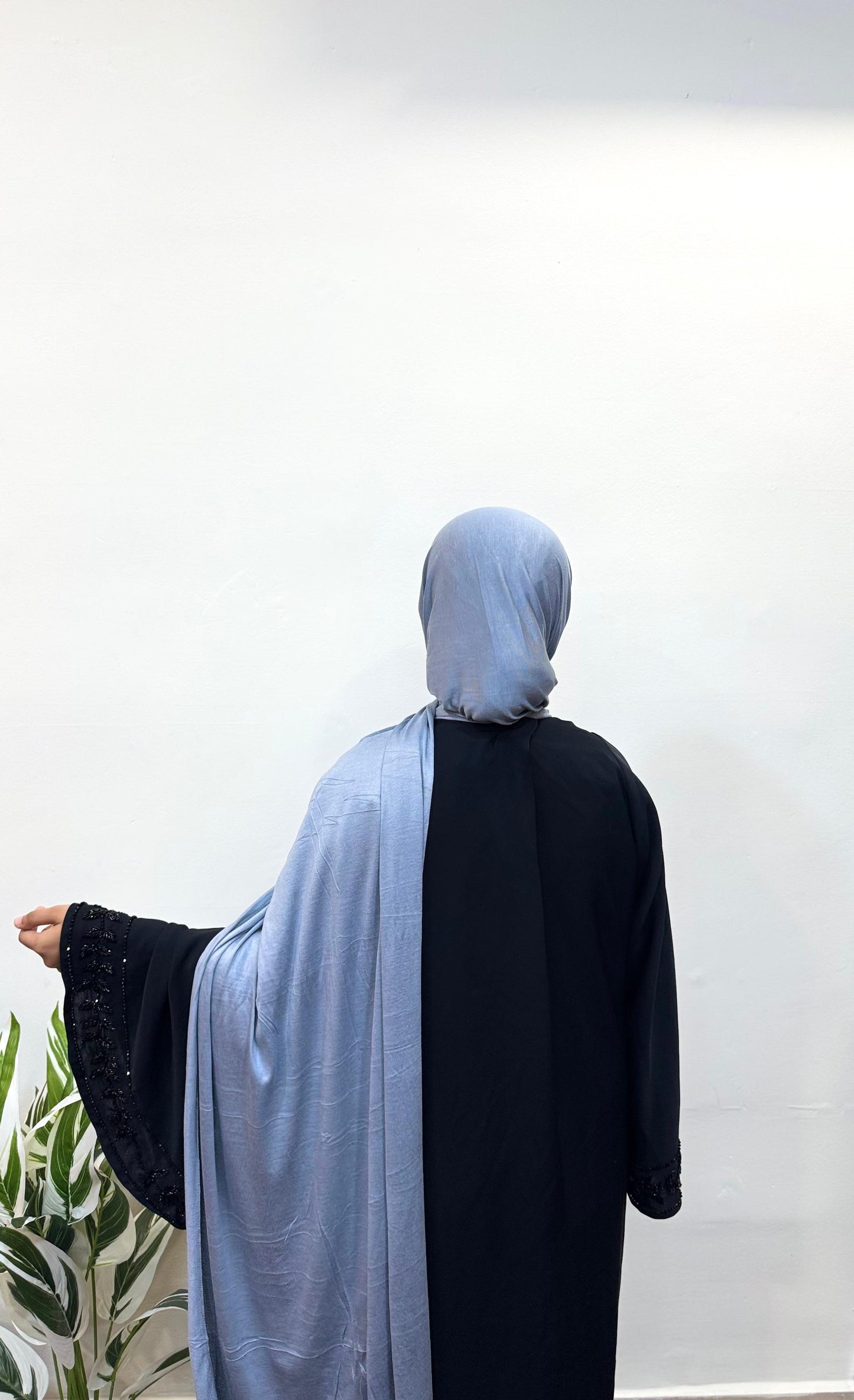 Back view of blue gray jersey hijab draped over shoulders.