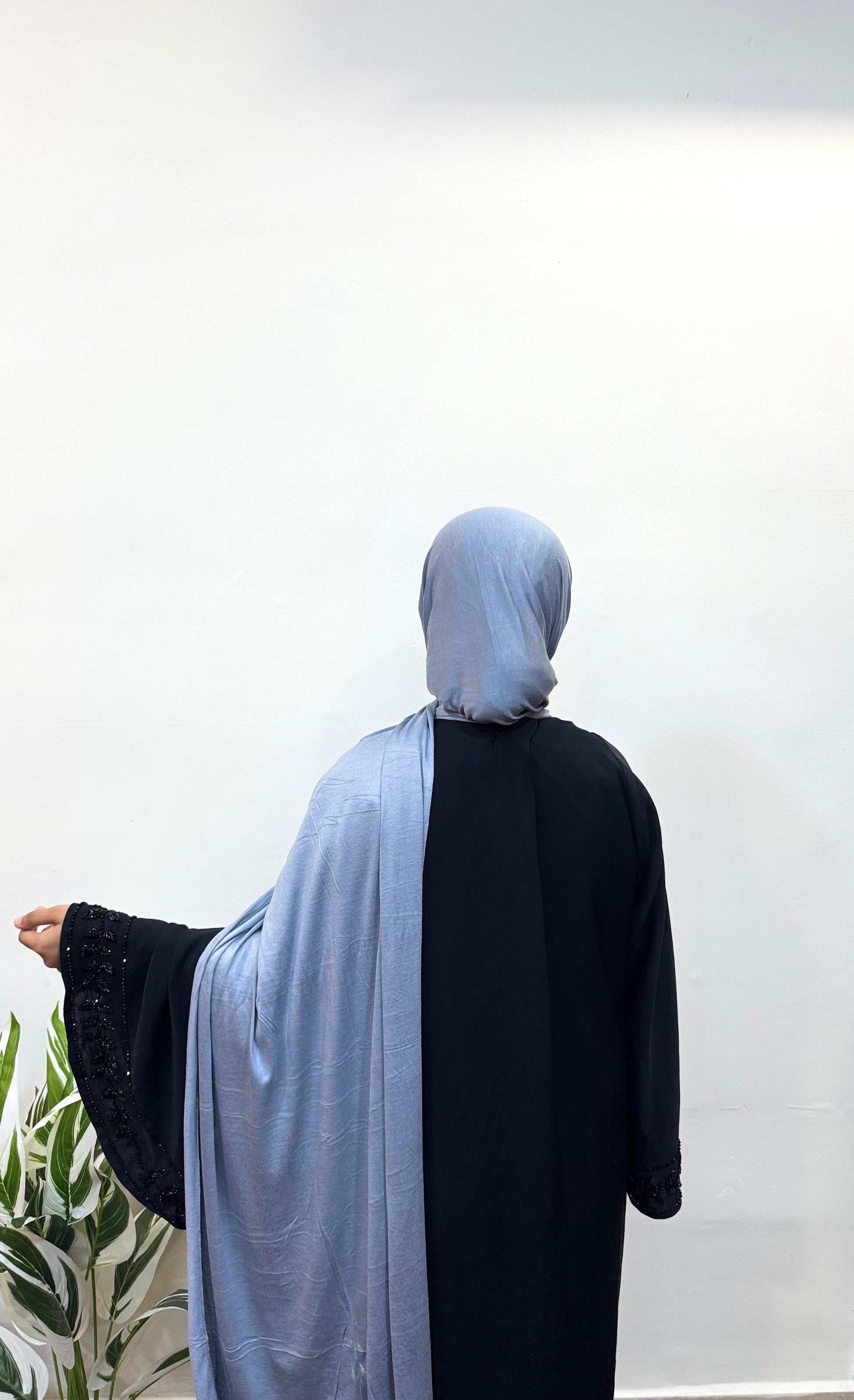 Back view of blue gray jersey hijab draped over shoulders.