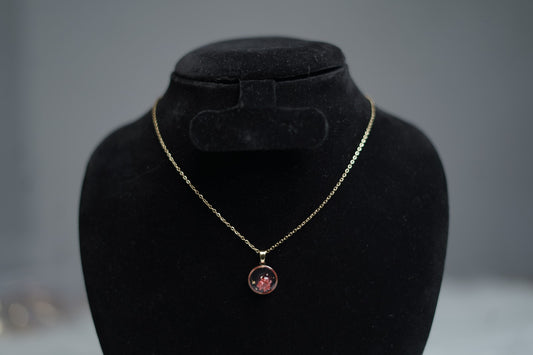 Close-up of Blush Bloom Necklace featuring dark pink resin flower pendant.