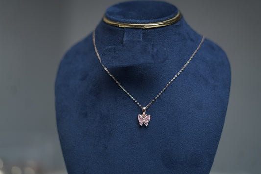 Close-up of pink butterfly pendant with sparkling crystals.