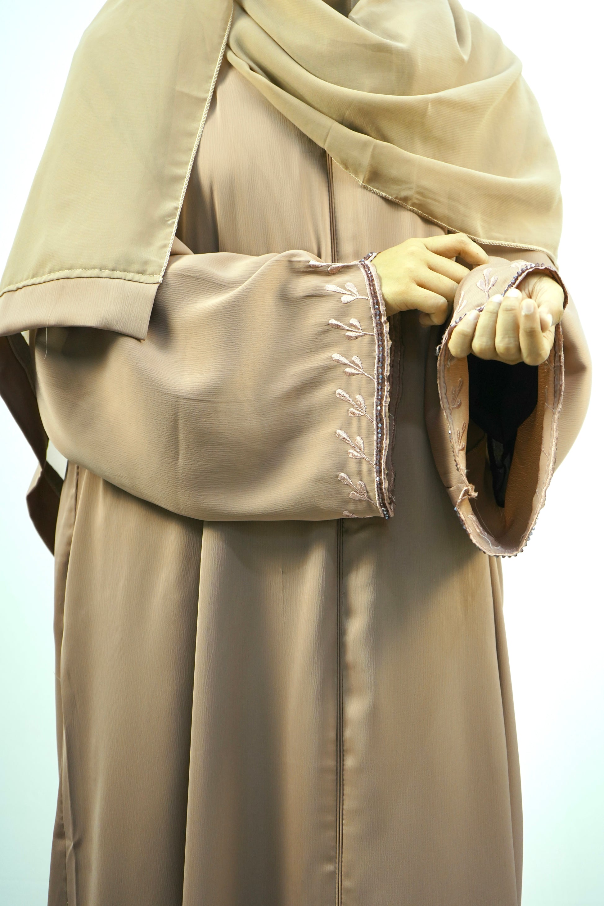 Close-up highlighting the smooth, flowing texture of the brown silky fabric of the Tiktok Indonesian Abaya.