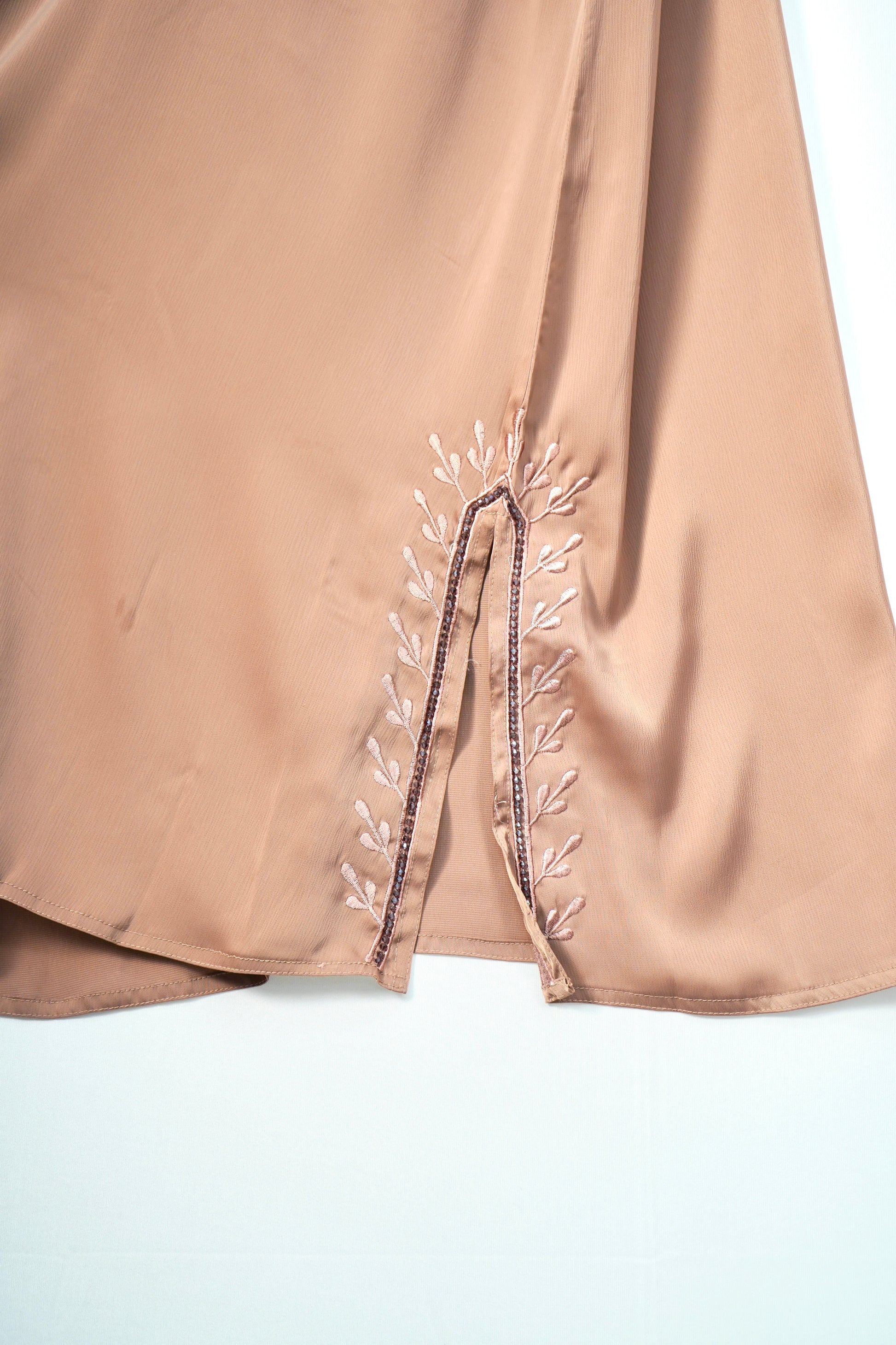 A detailed close-up of the elegant embroidery on the side slit of the Tiktok Indonesian Abaya.