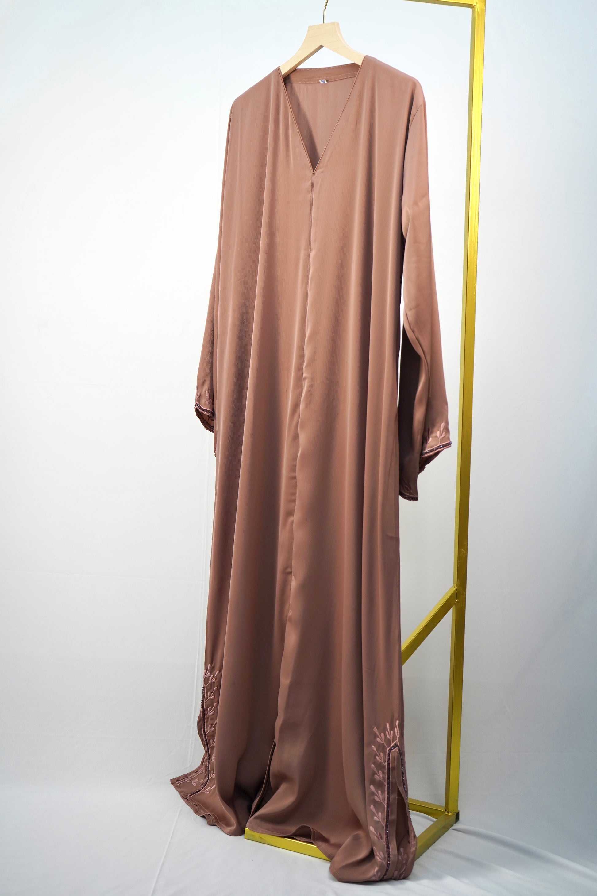 A full-shot of the Tiktok Indonesian Abaya, highlighting its silky texture, classic V-neck, and embroidered details.