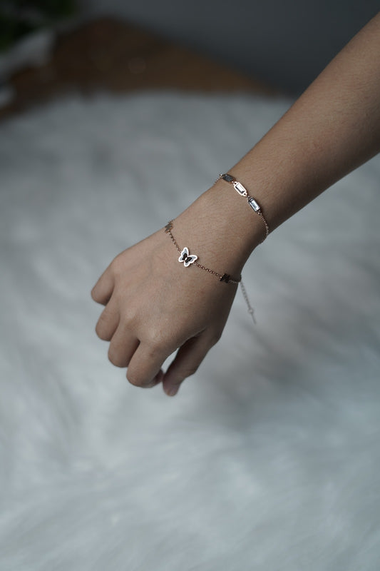 Butterfly Garden Bracelet worn on wrist, showing both chains and central butterfly charm.