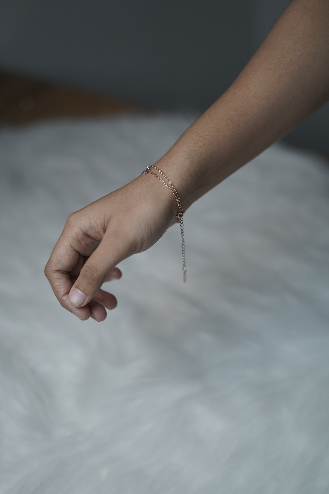 Side view of the Butterfly Garden Bracelet on wrist, showing layered chains and soft drape.