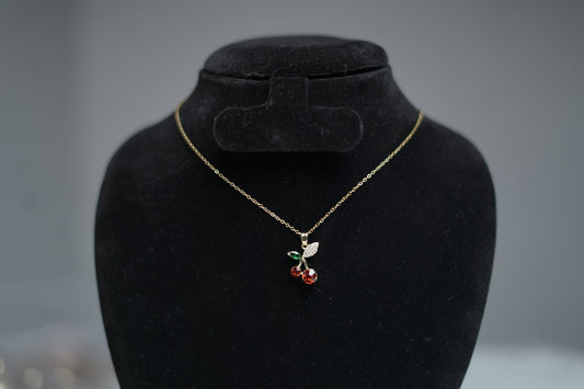 Gold chain Cherry Bloom Necklace displayed on neutral stand background.