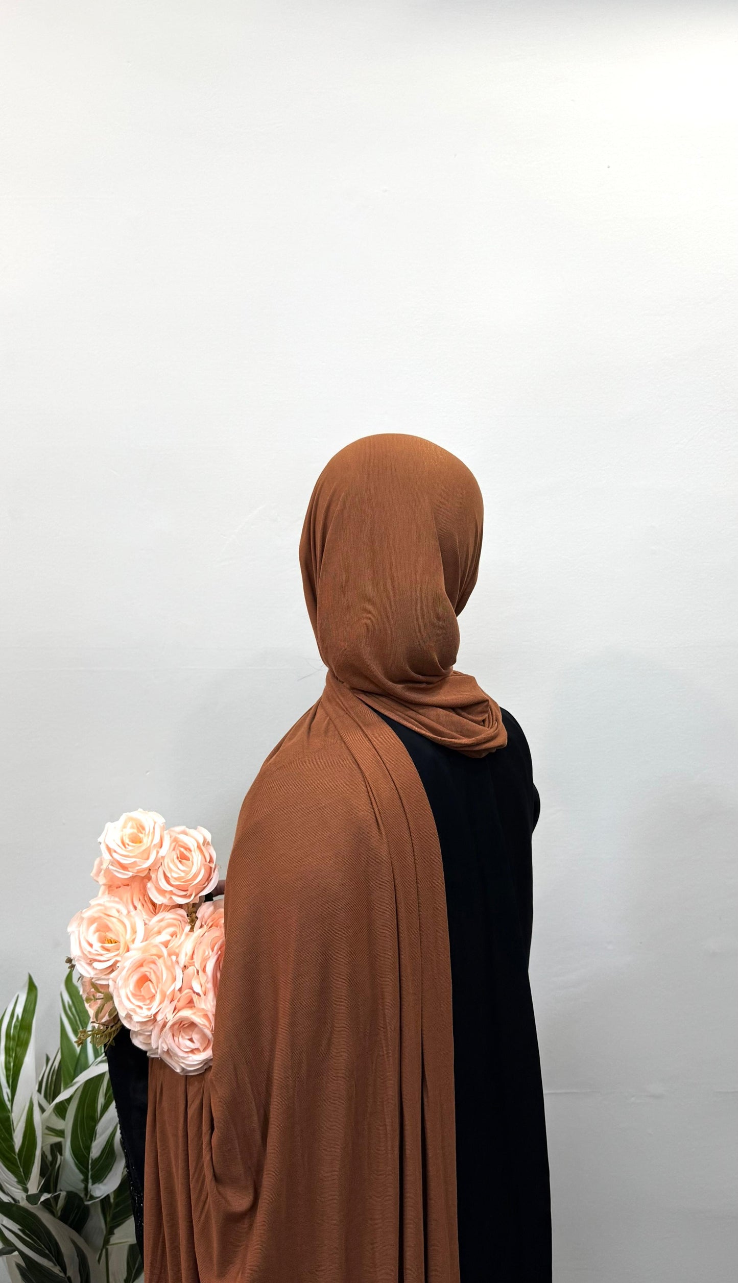 Copper jersey hijab draped loosely for a casual look.