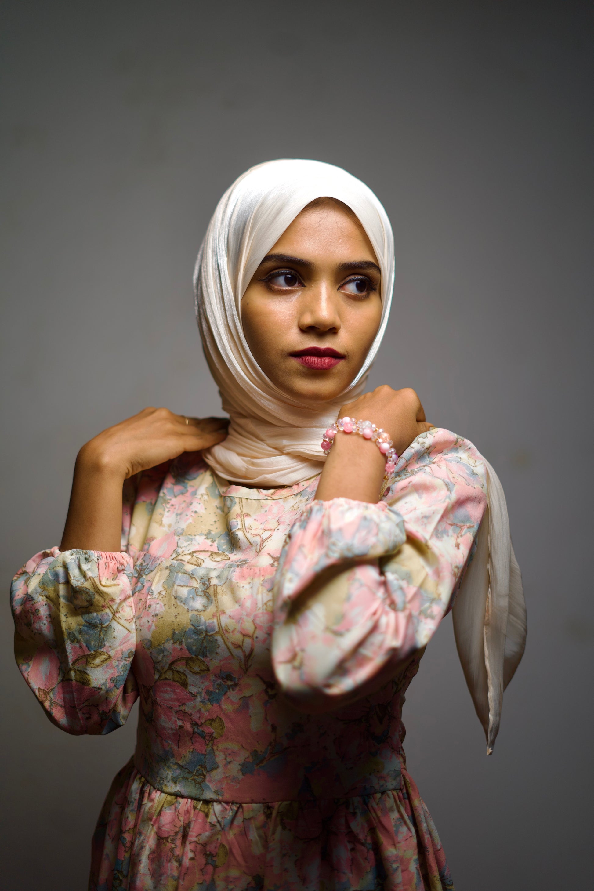 Light cornsilk hijab with glossy accents, gently wrapped around the face.