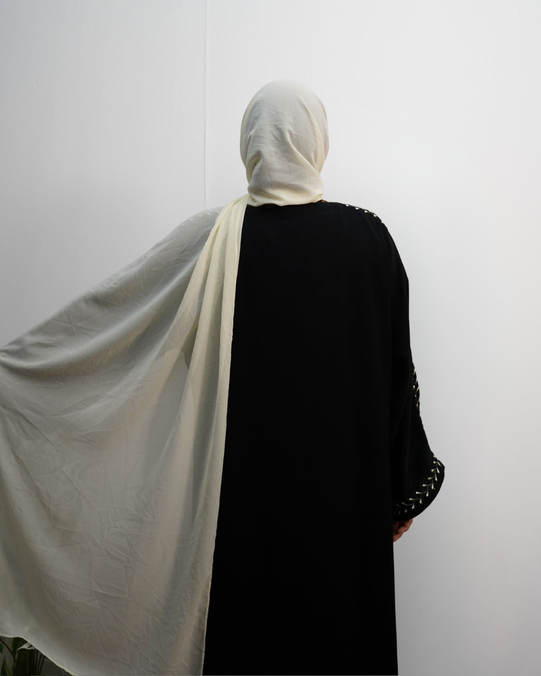 Cream chiffon hijab shown spread wide, highlighting its soft flowy texture.