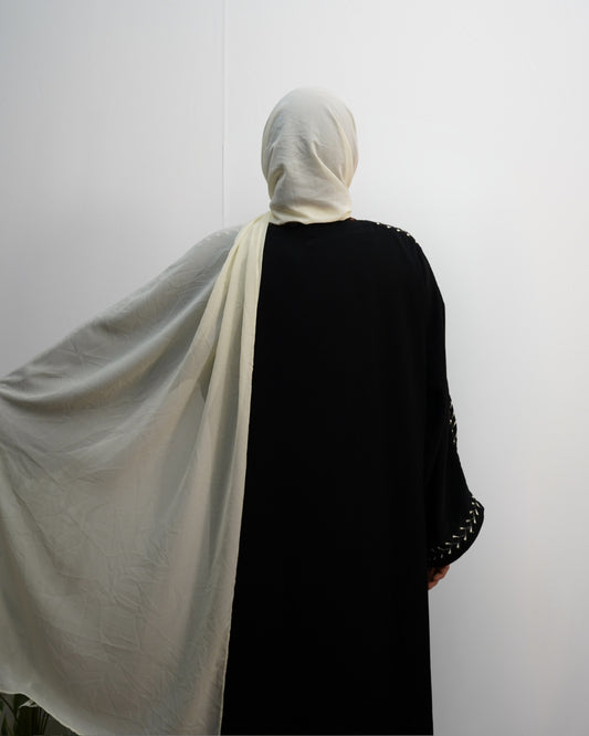 Cream chiffon hijab shown spread wide, highlighting its soft flowy texture.