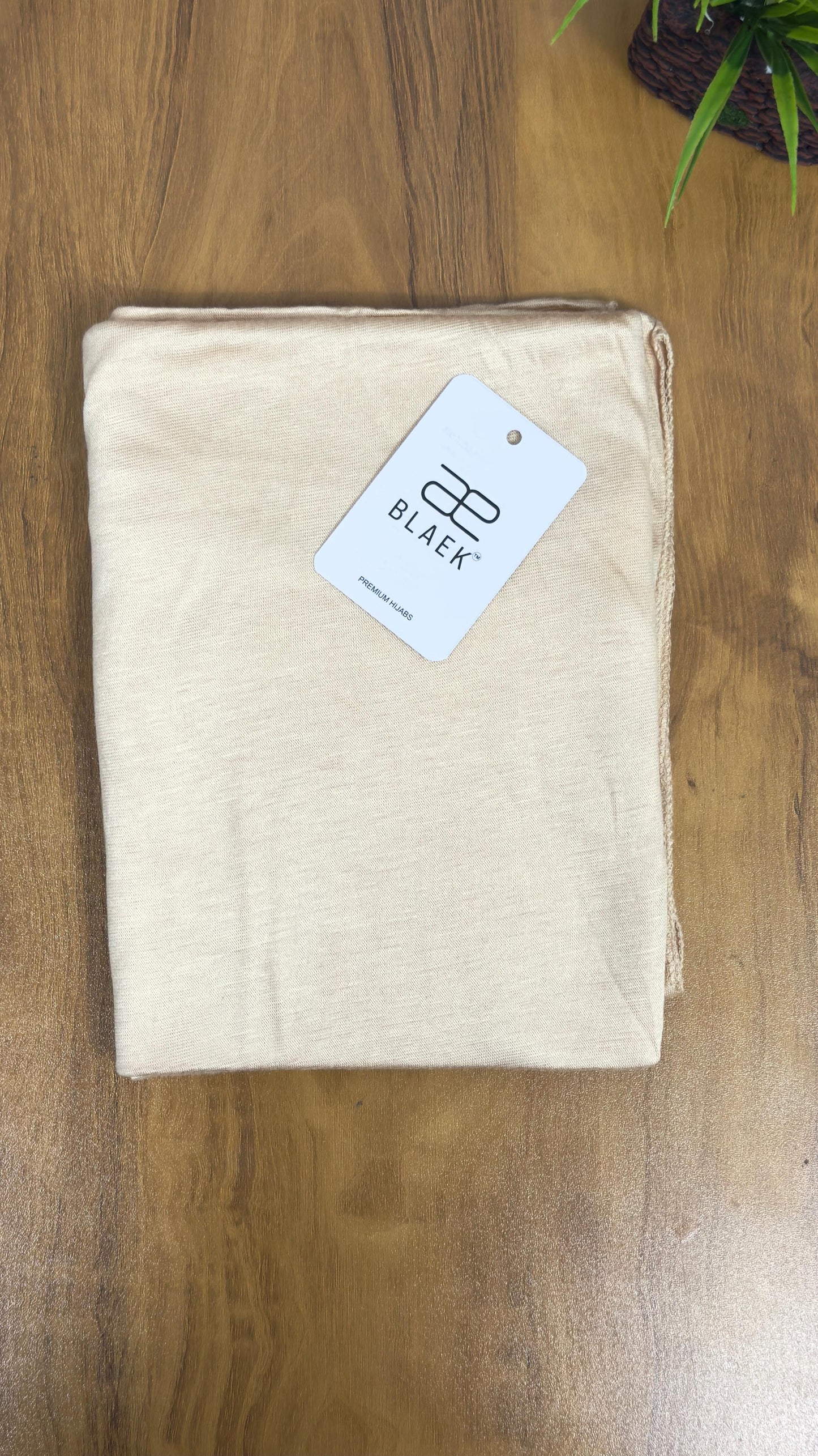 Warm-toned cream jersey hijab with a non-slip finish.