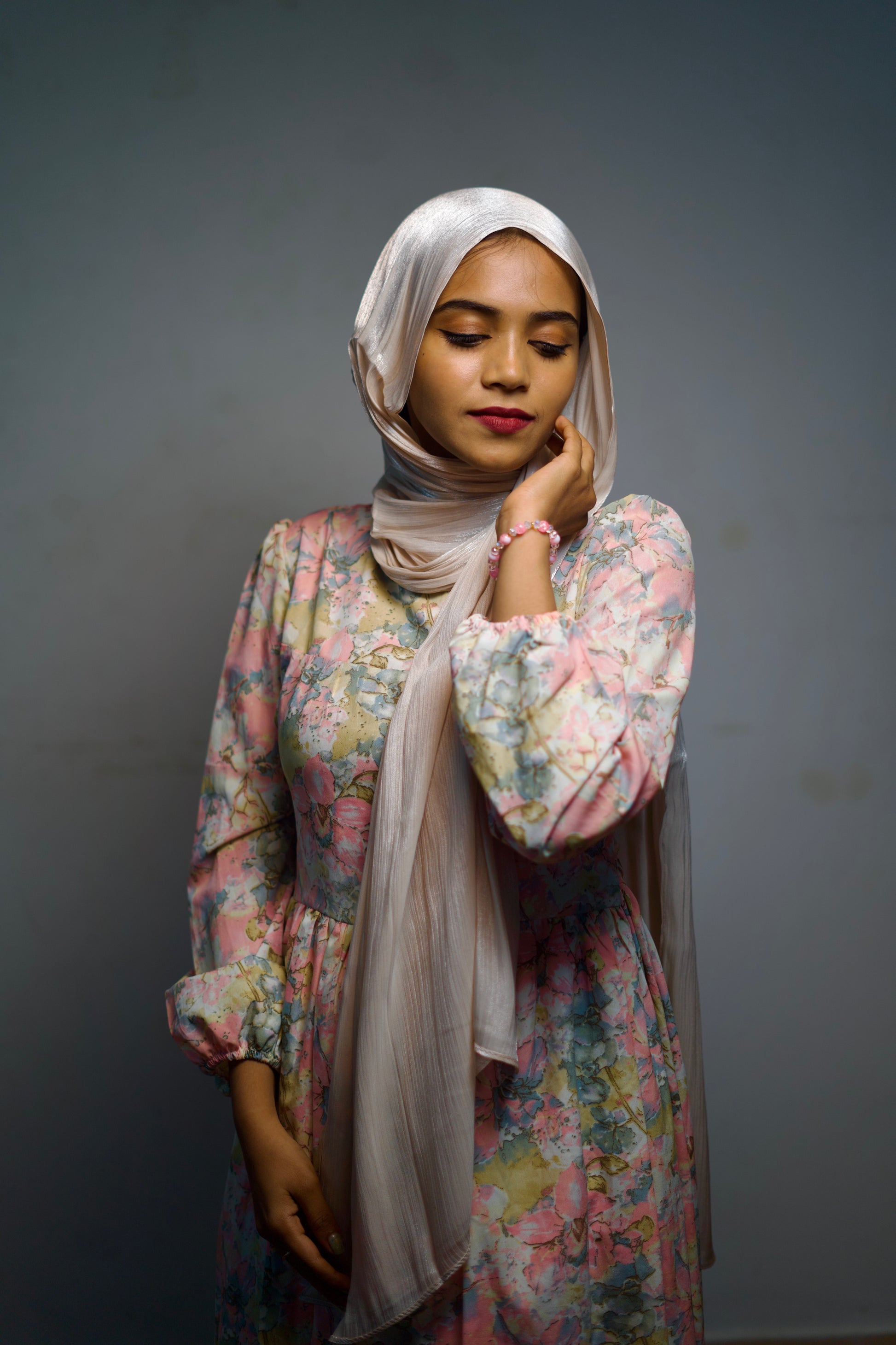 Woman wearing a light cream shimmer hijab.