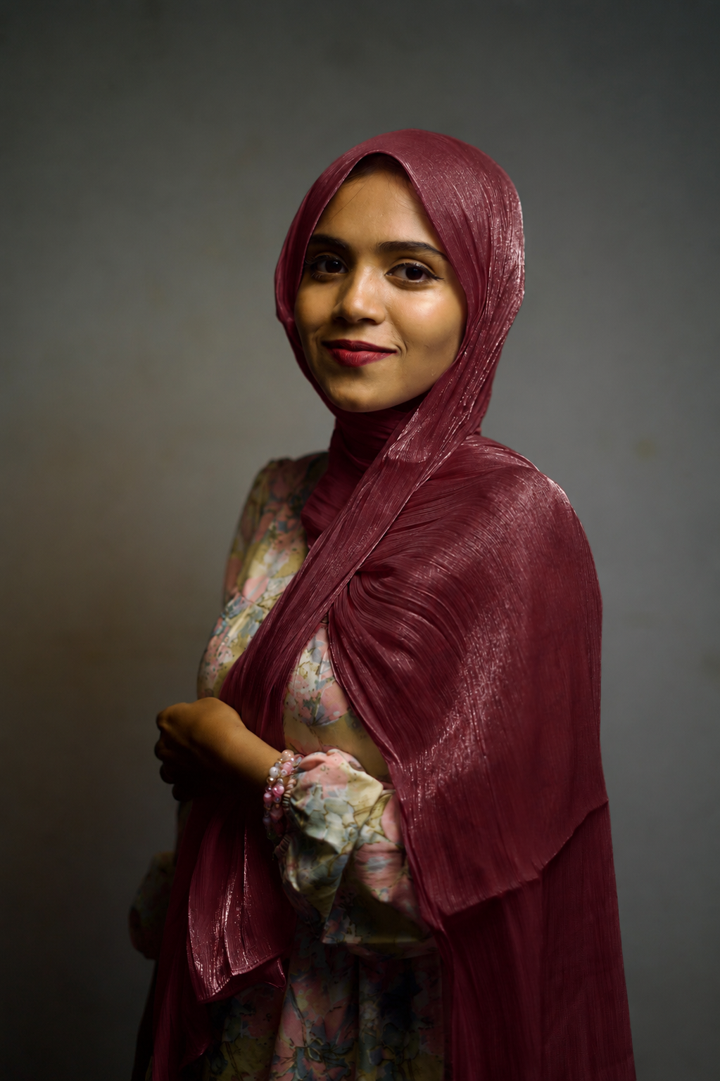 Woman wearing Dark Burgundy shimmer hijab with soft elegant draping