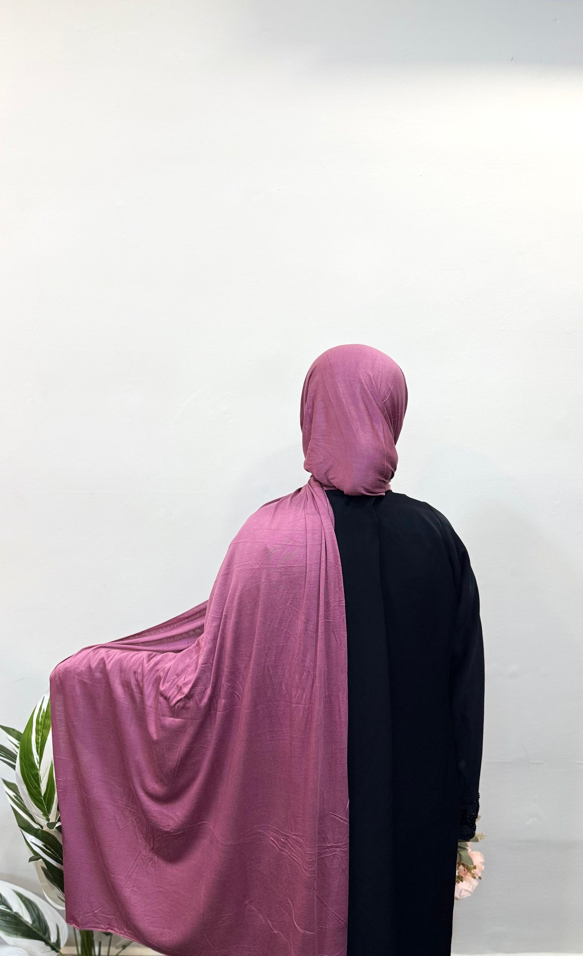 Model showcasing soft stretch dark pink jersey hijab.