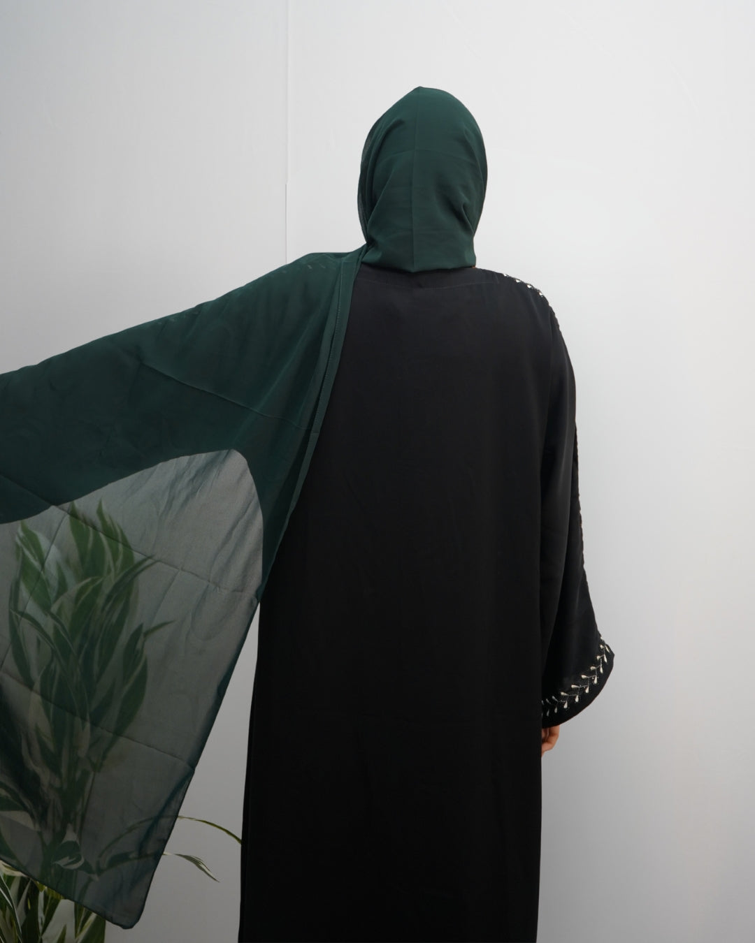Deep green indian chiffon hijab with semi-sheer texture, spread out to show drape and flow.