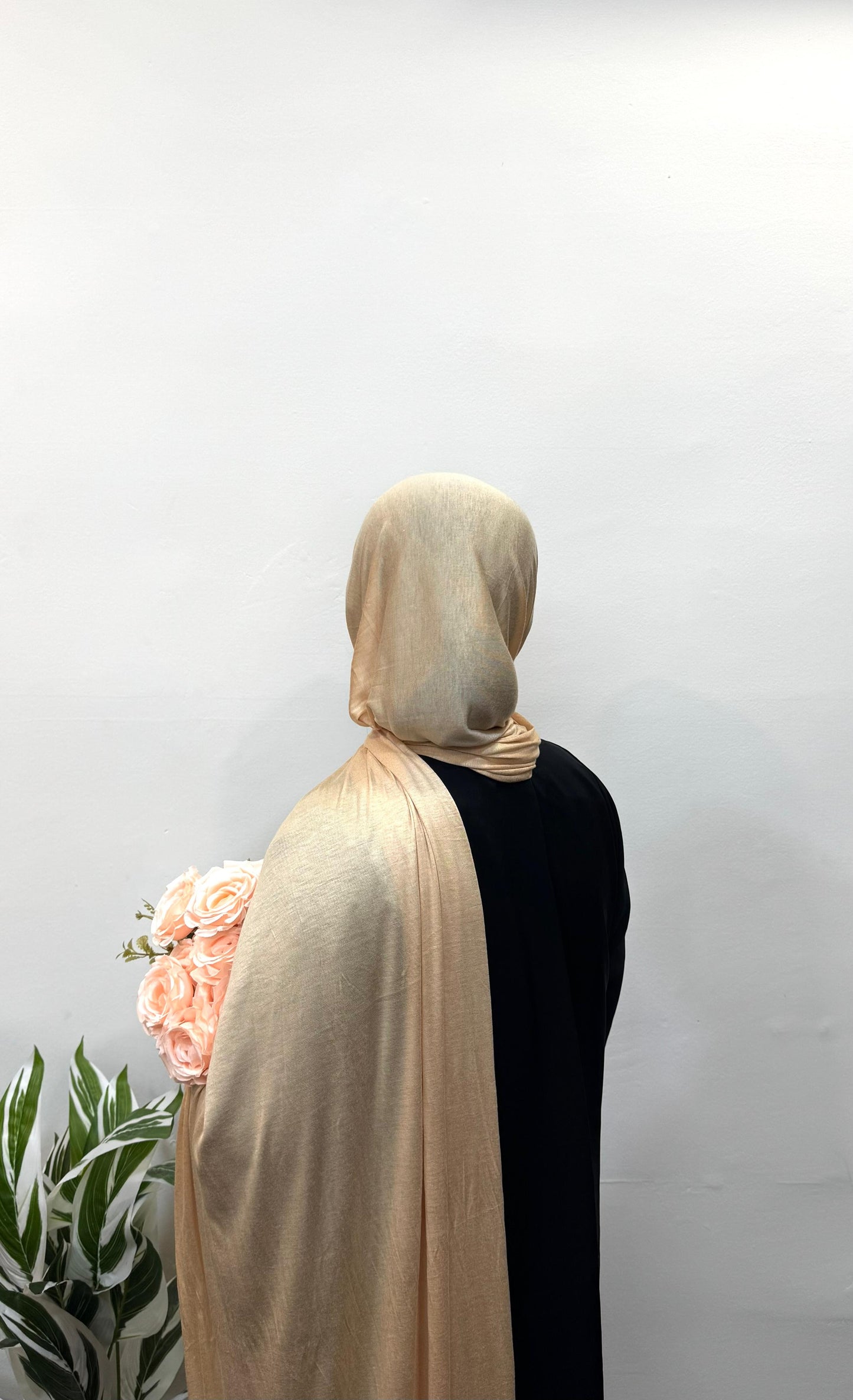 Desert yellow jersey hijab draped softly in natural light.