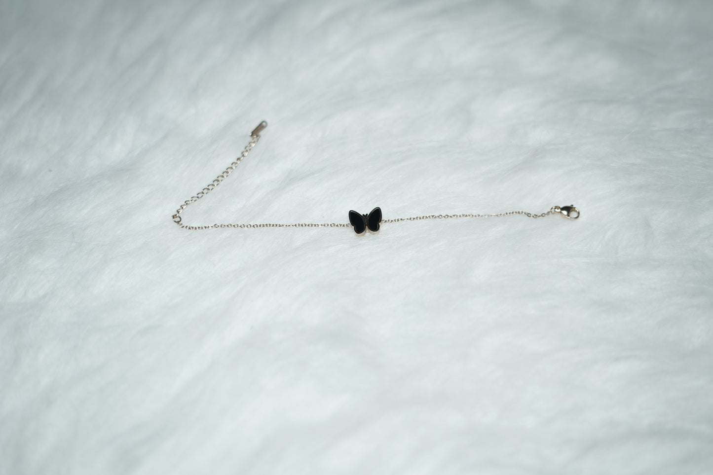 Dual Sided Butterfly Bracelet shown with the black side facing out against a soft background.
