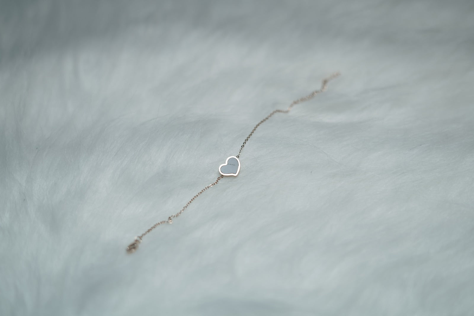 Dual Sided Heart Bracelet displayed with the black heart side turned up on a neutral background.