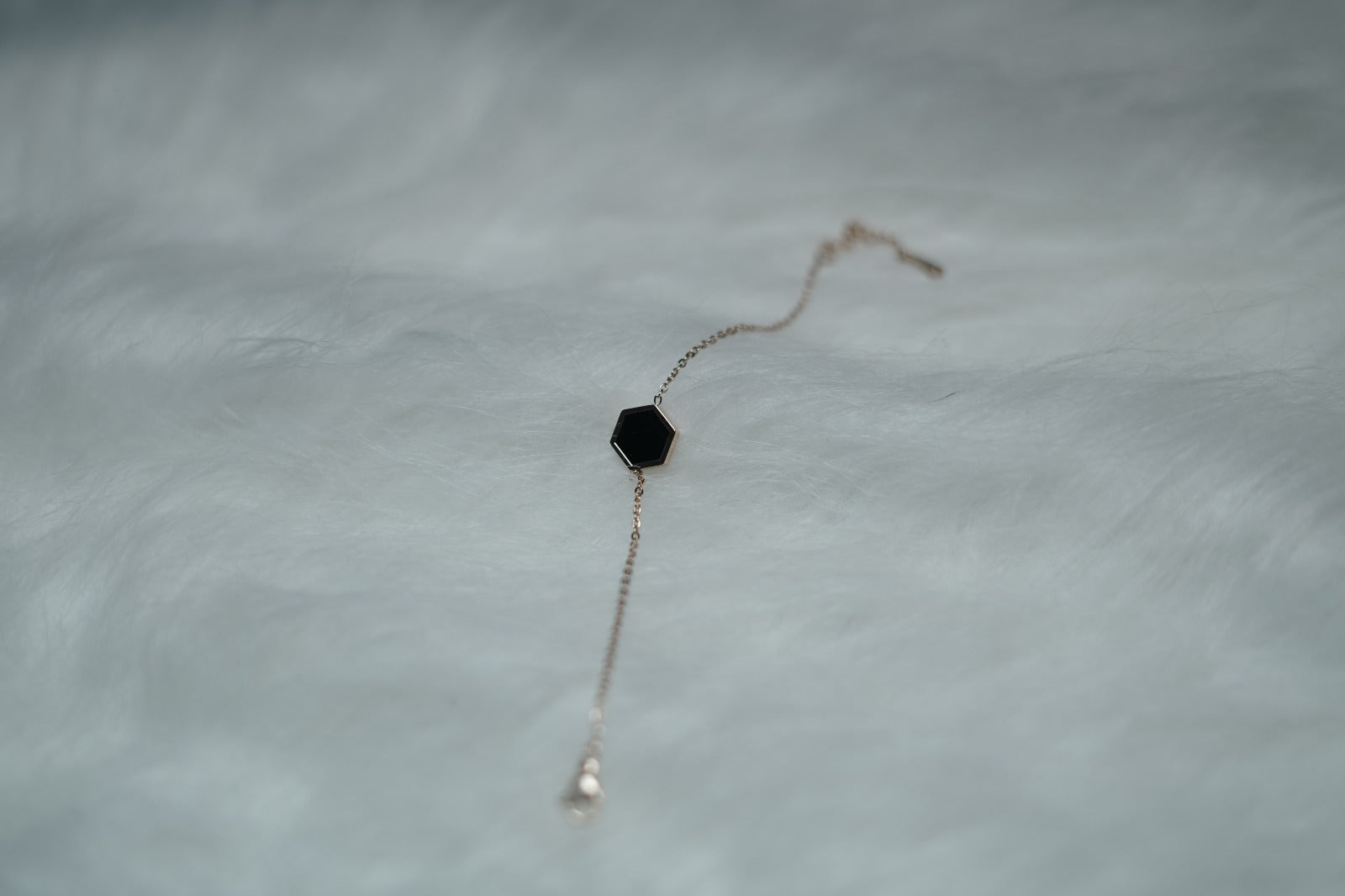 Bracelet displayed flat with the black hexagon side facing up for a bold look.