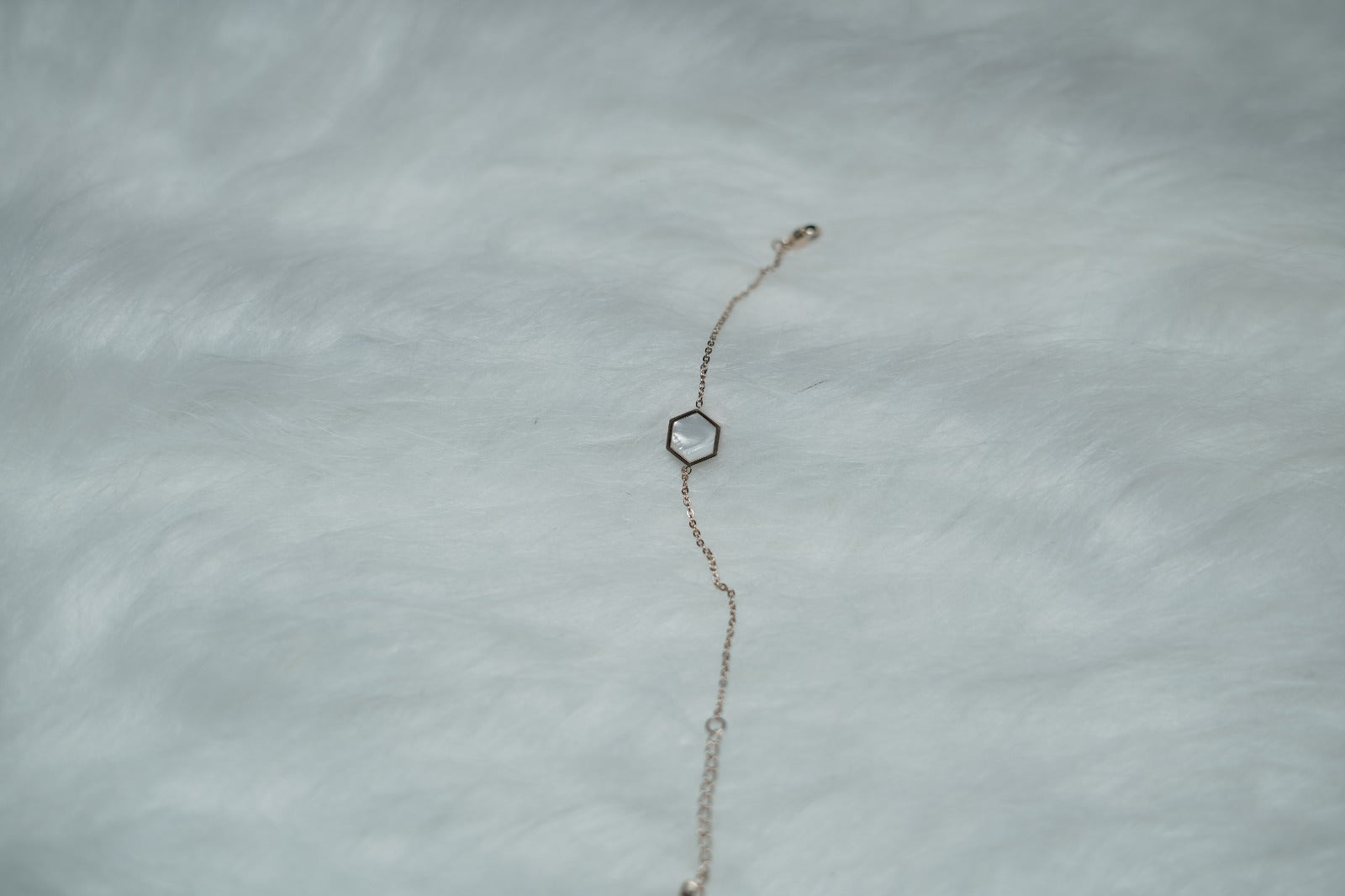 Zoomed-in view of the bracelet with the white side of the bold hexagon charm.