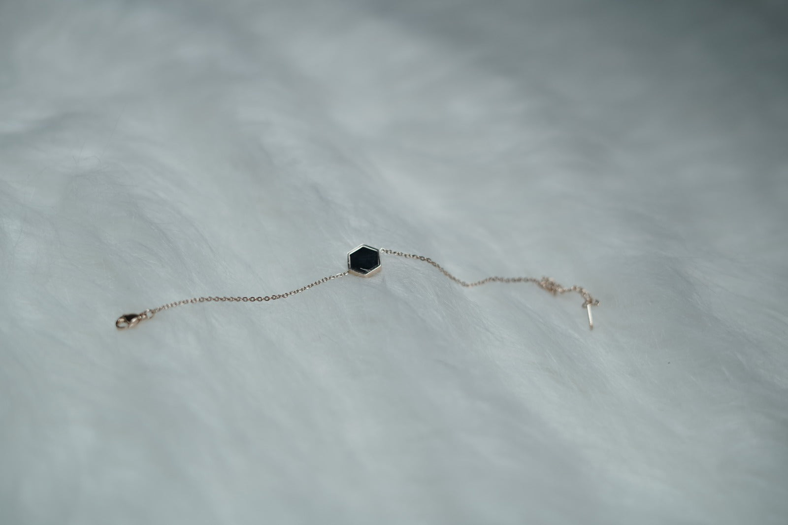 Dual Sided Hexa Bracelet captured with the black side of the hexagon charm in focus.