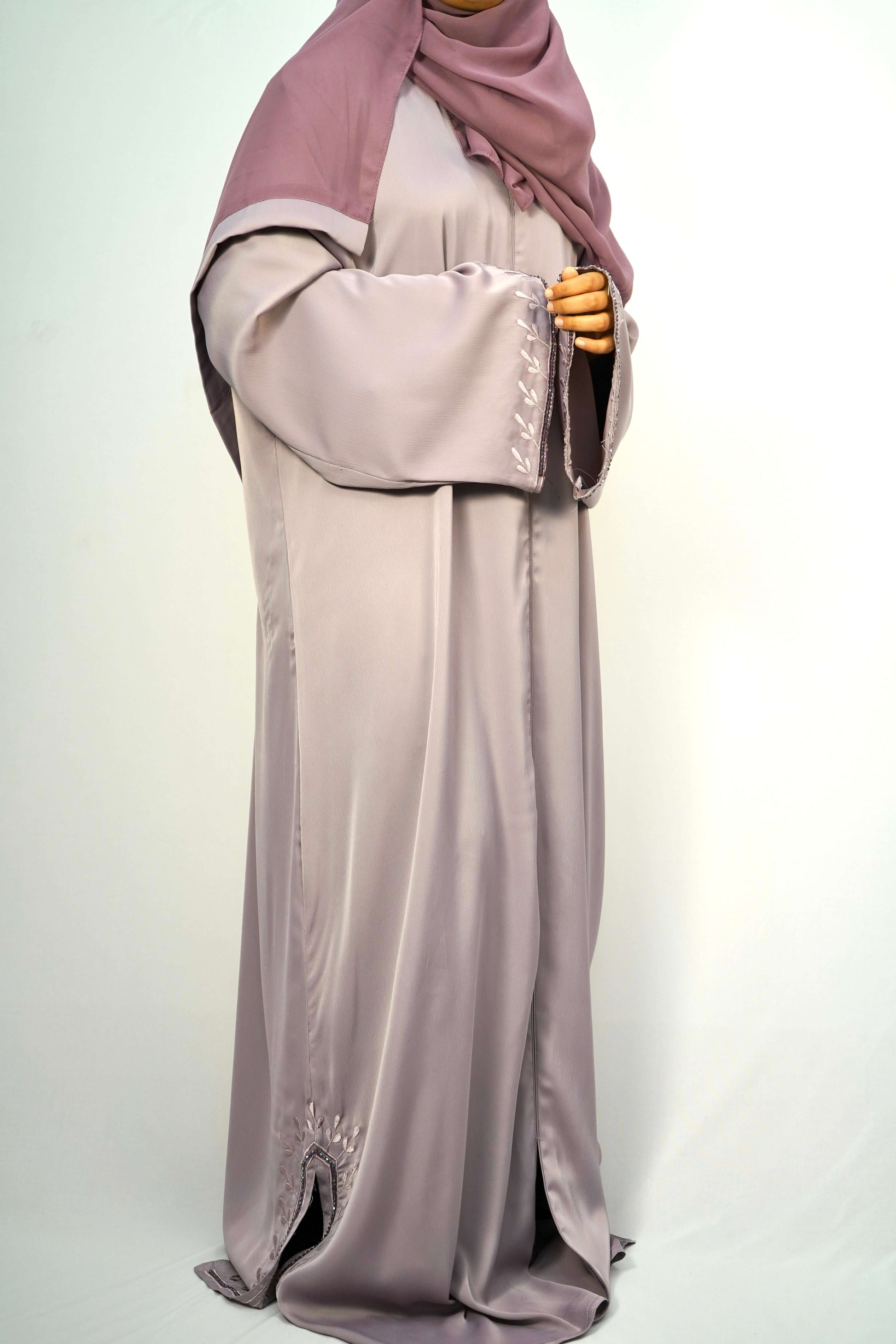 A side view of a woman wearing the Tiktok Indonesian Abaya, highlighting the flow of the silky fabric.