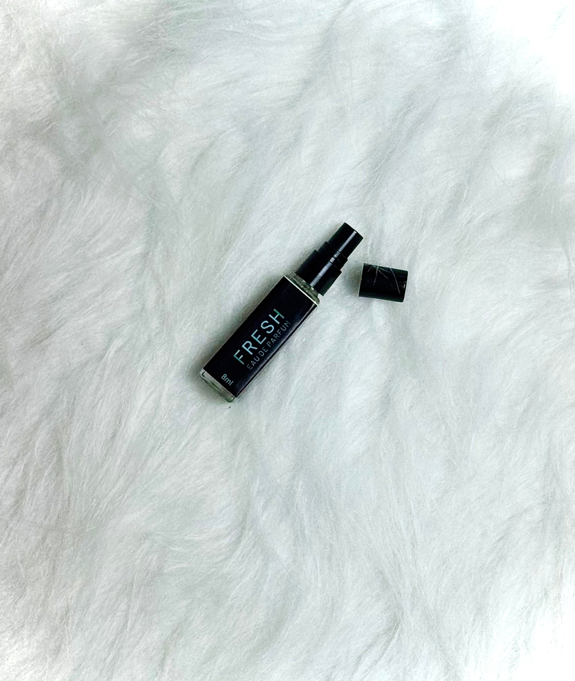 Fresh Perfume 8ml lying on white with cap off, showing the bottle opening.
