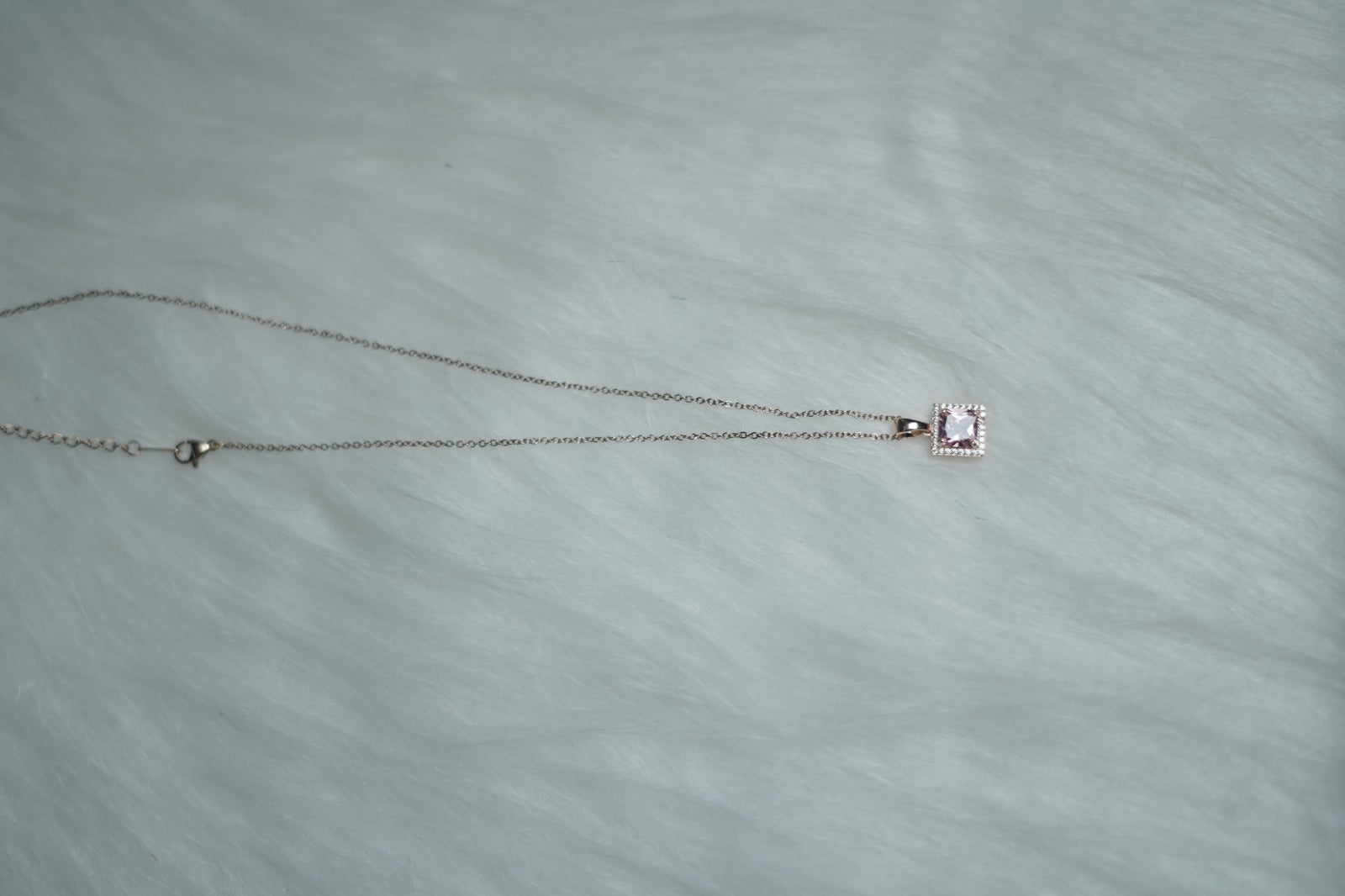 Lavender Luxe Necklace displayed on soft white fur background.