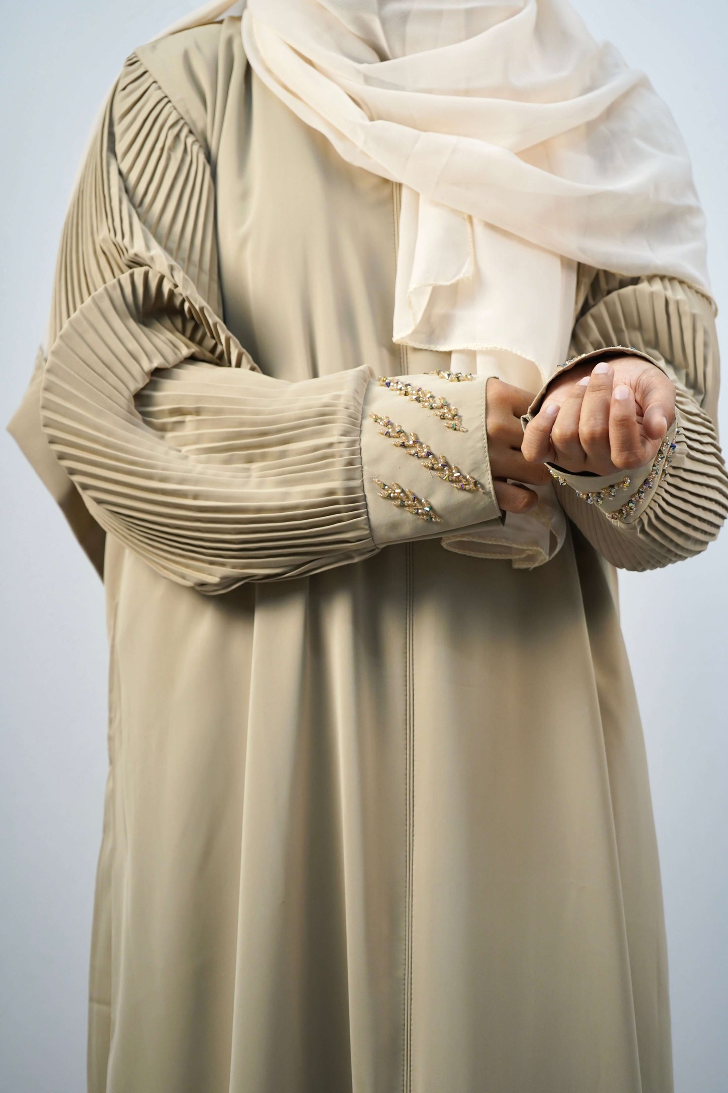 A close-up of the elegant beaded cuffs and pleated sleeve design on the Korean Alqa Nidha Abaya.