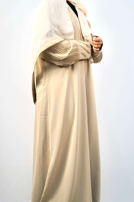 A side view of a woman wearing the Korean Alqa Nidha Abaya, showcasing the fabric and the detailed pleated sleeves.