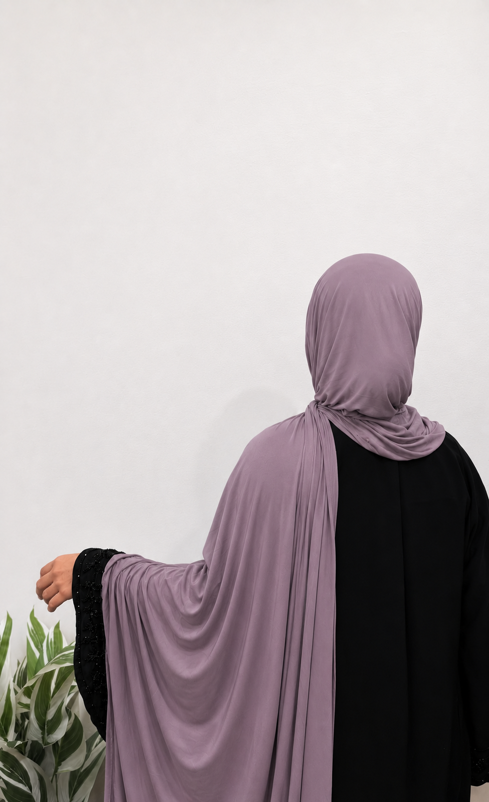 Woman wearing a Mauve Jersey Hijab with soft drape and full coverage