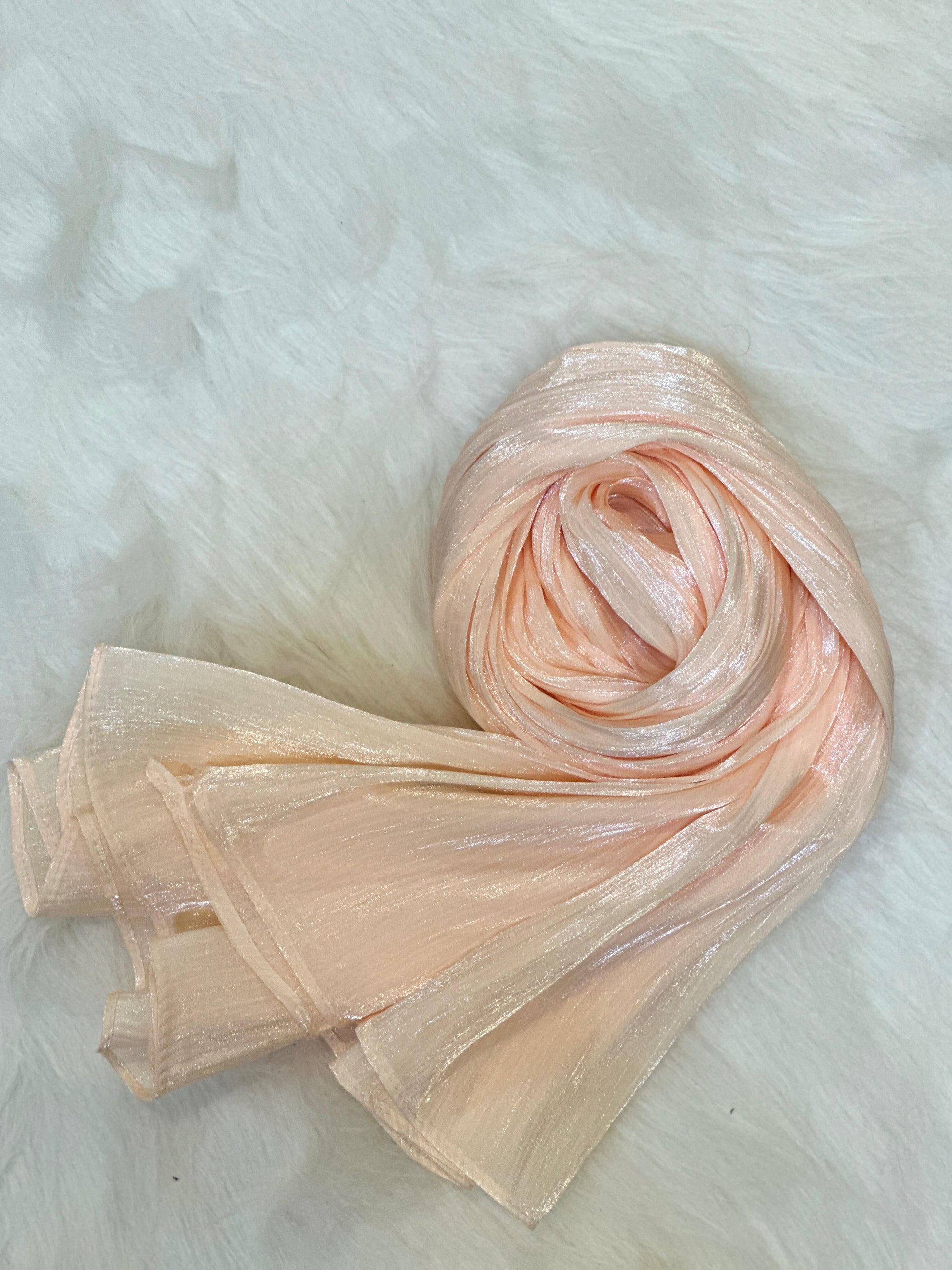 Rolled shimmer hijab in pastel pink shade, showing fine fabric detailing.