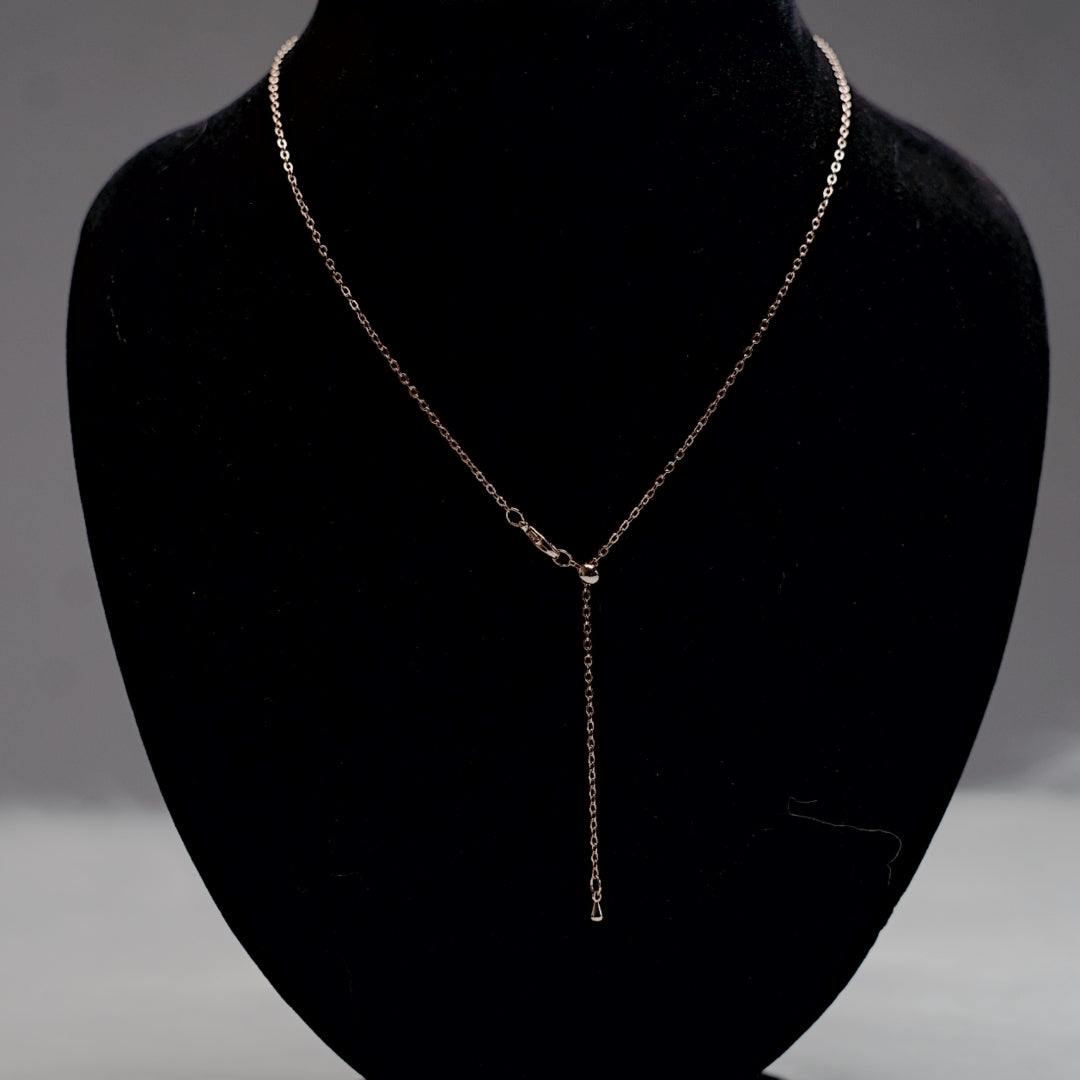 Rose gold chain with multicolor stone pendants.