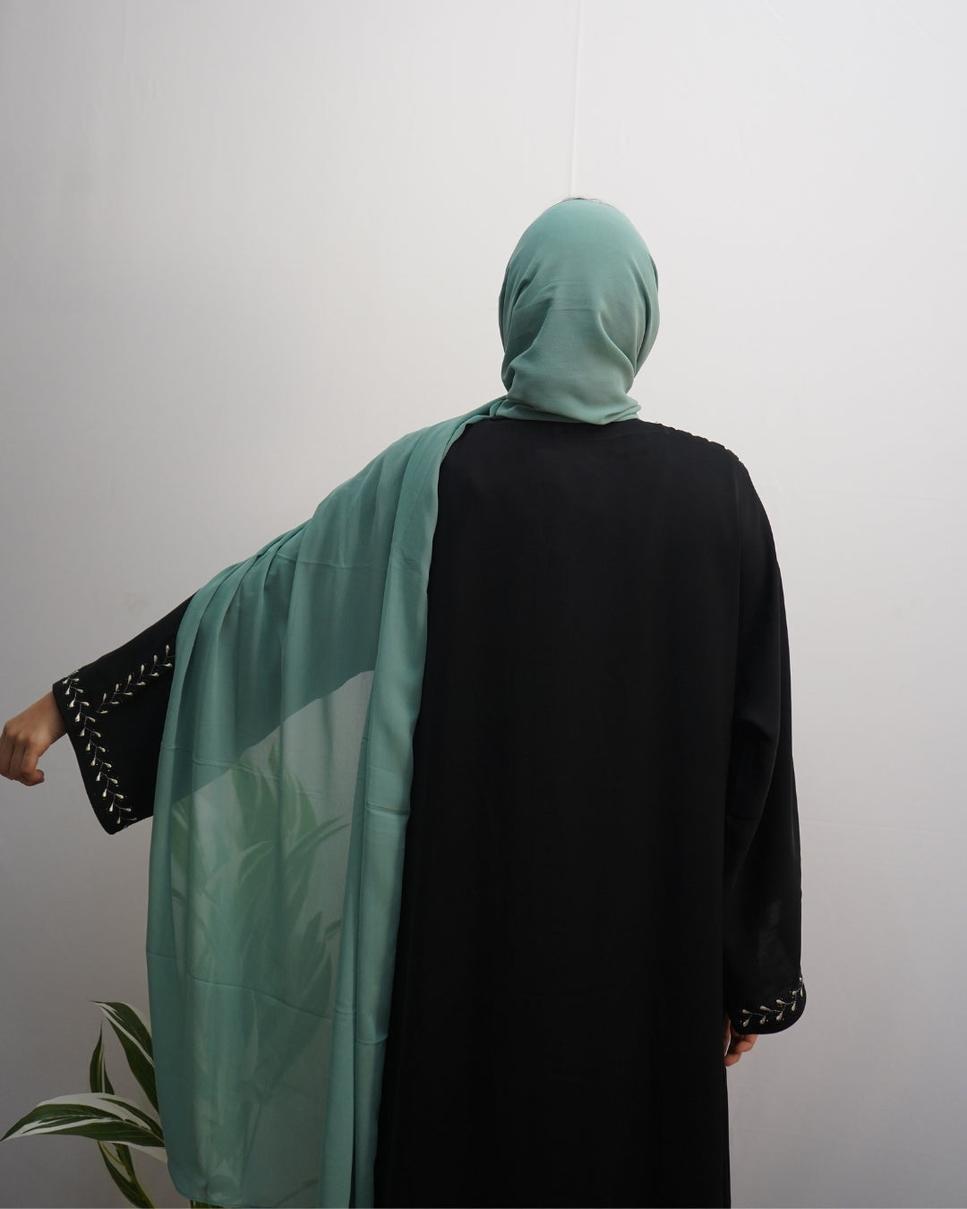 Flowy mint green chiffon scarf with smooth texture and neat finish.