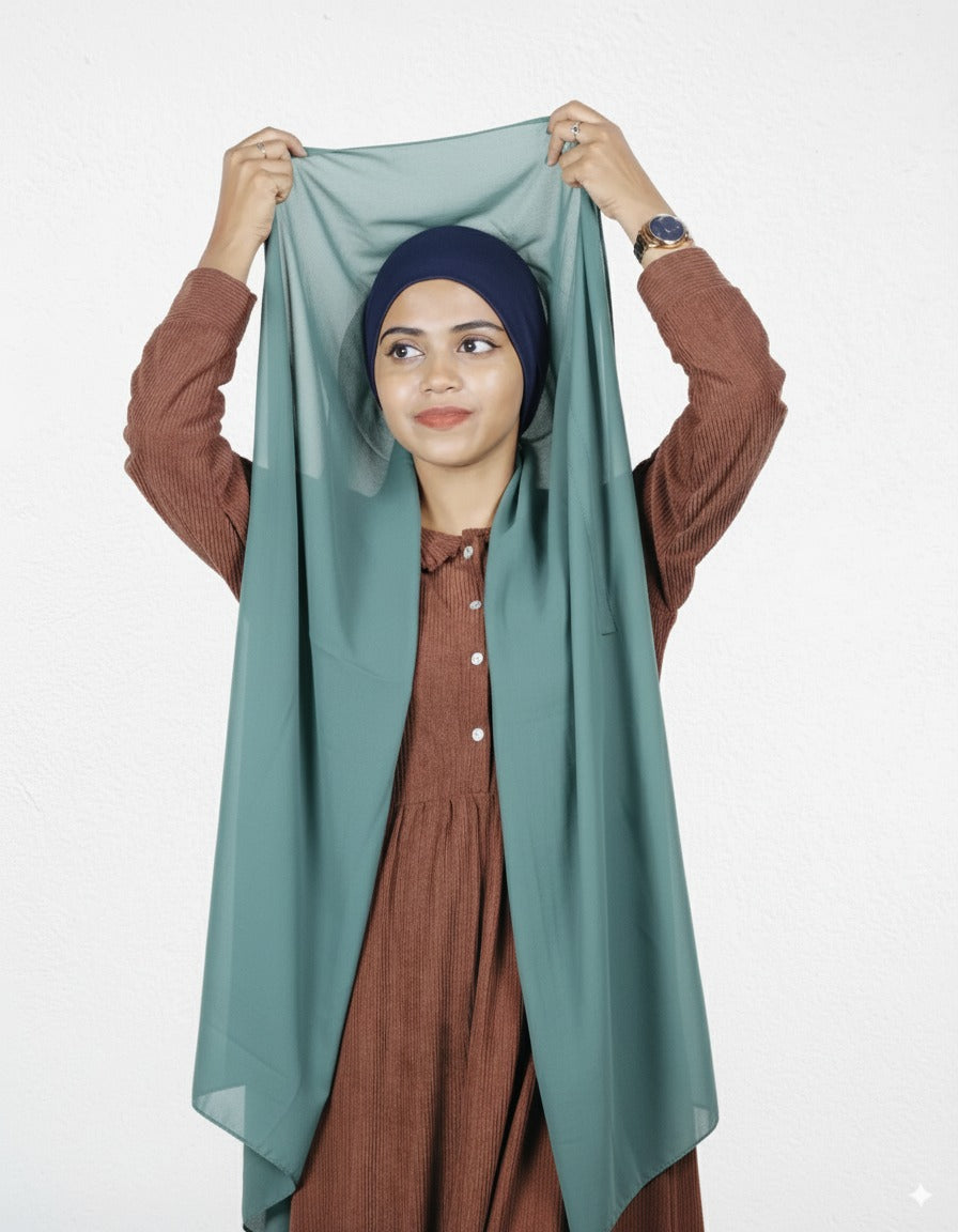 Mint green chiffon instant hijab with navy blue cap for modest fashion.