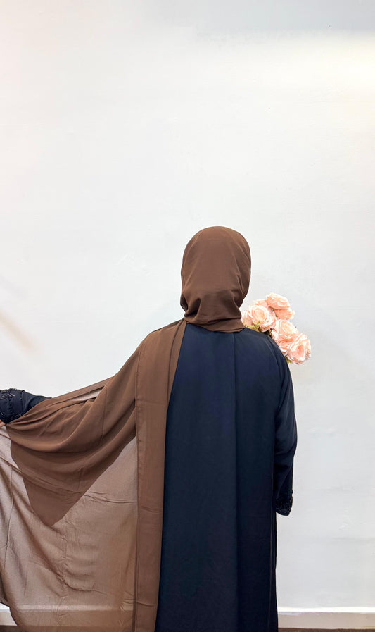 Back view of a woman wearing a mocha chiffon scarf.